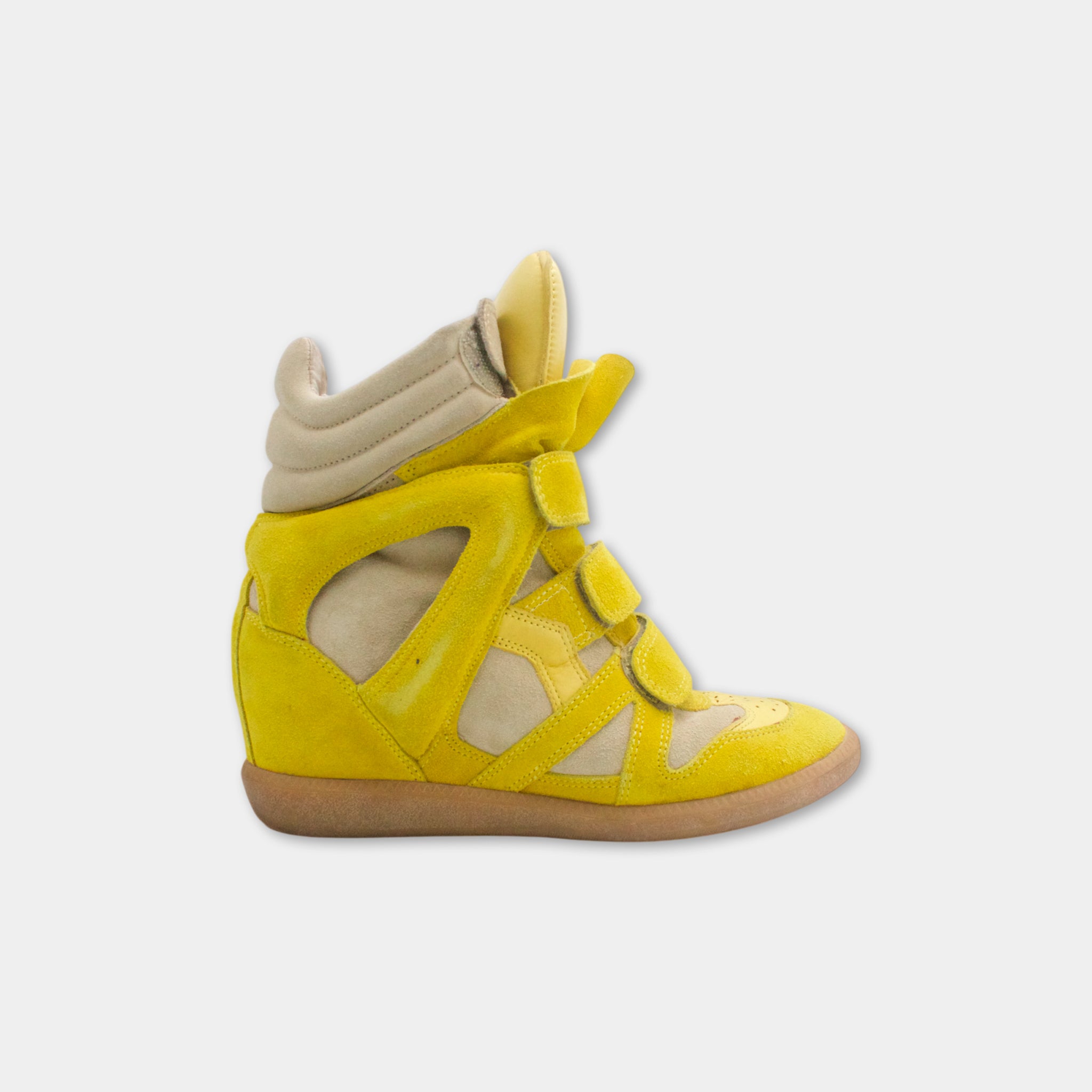 A yellow and beige high-top sneaker with a distinctive design.