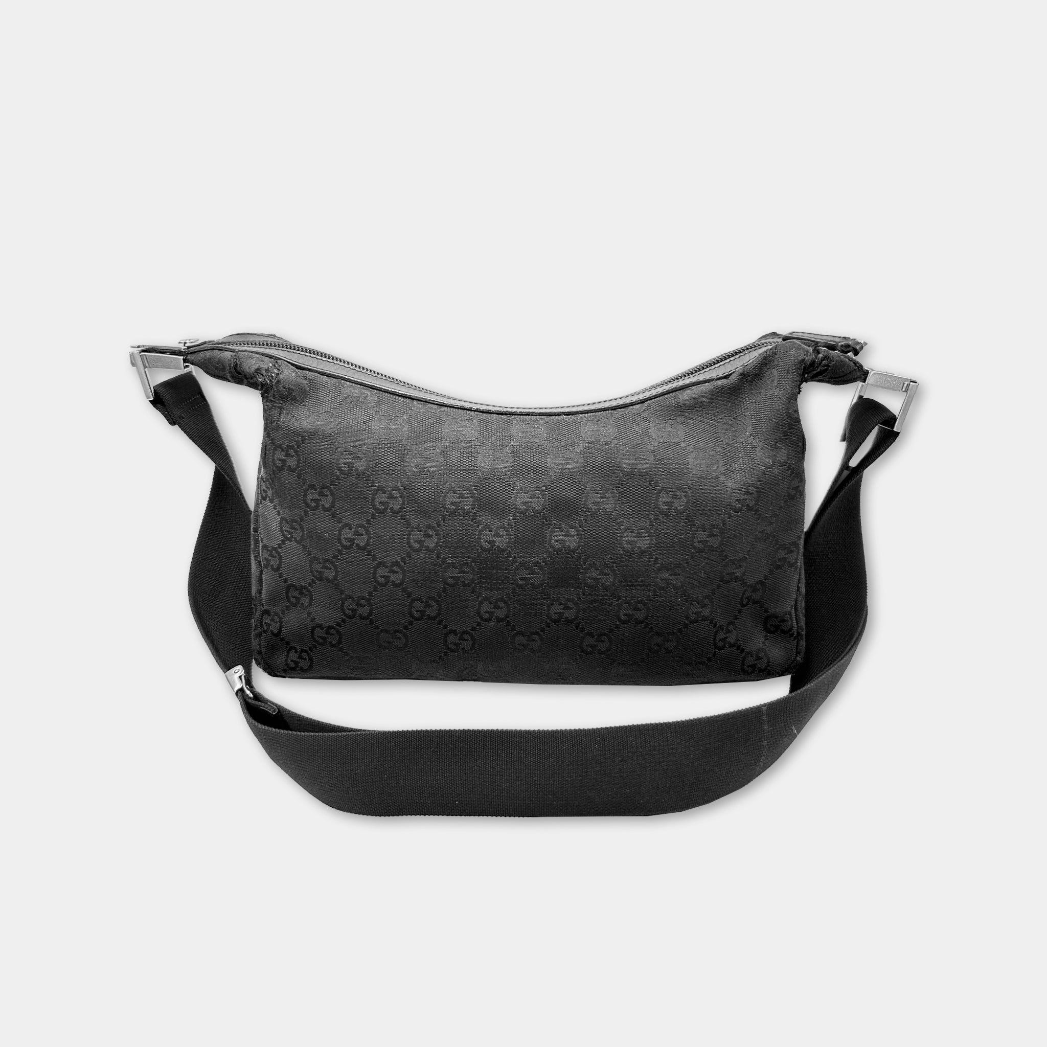 A black Gucci handbag with a distinctive monogram pattern.