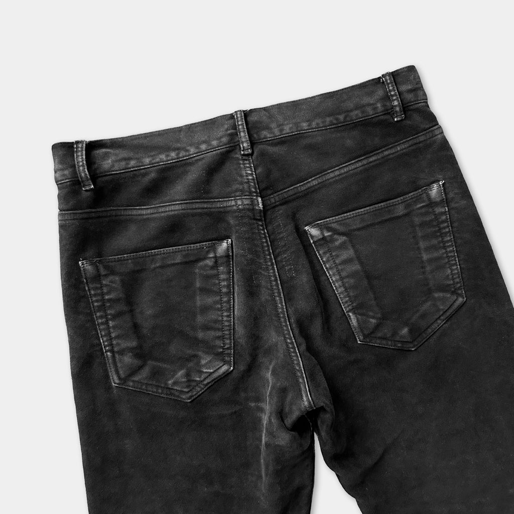 a pair of black jeans with visible pockets and a zipper.