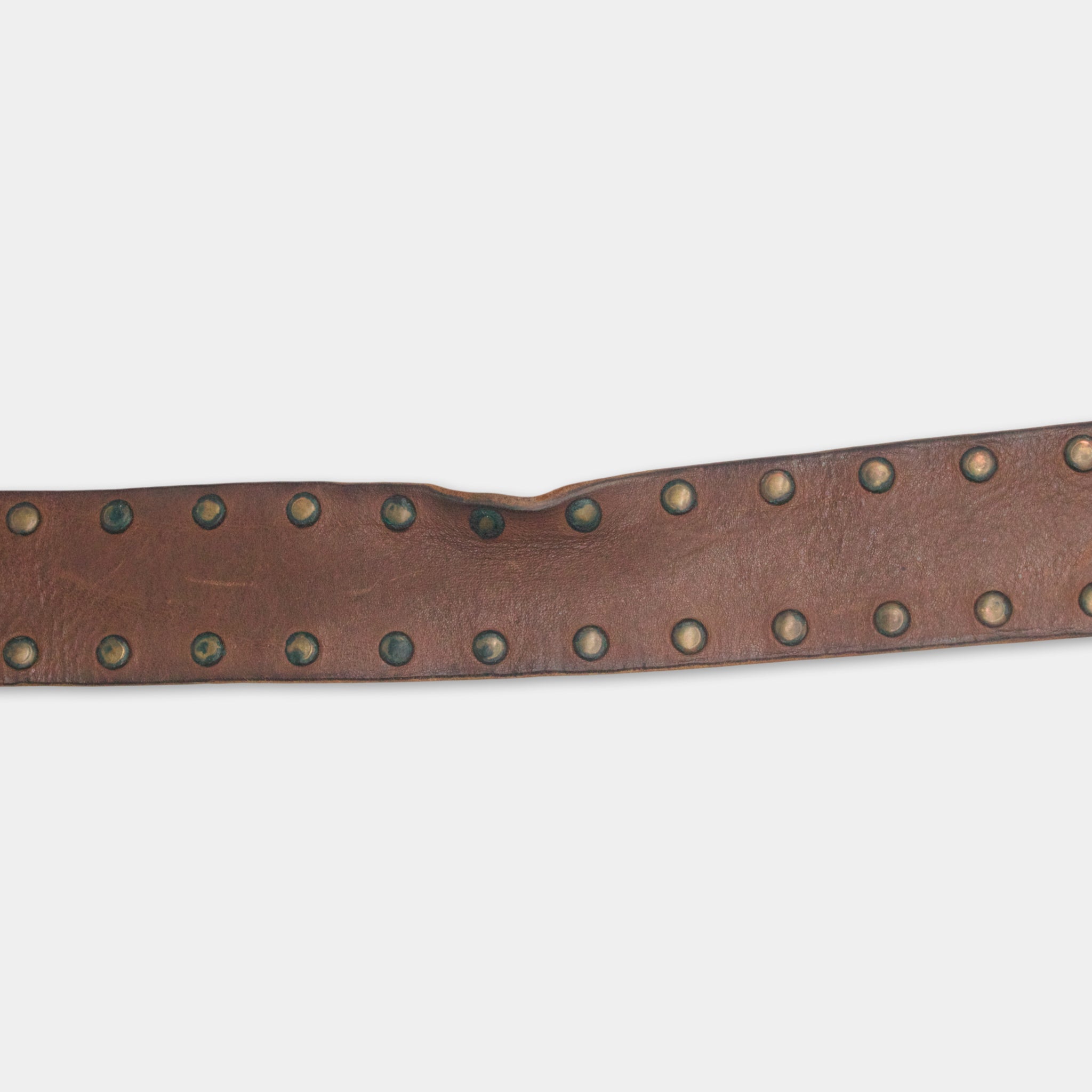 A brown leather belt with a row of small circular studs or rivets along its length.