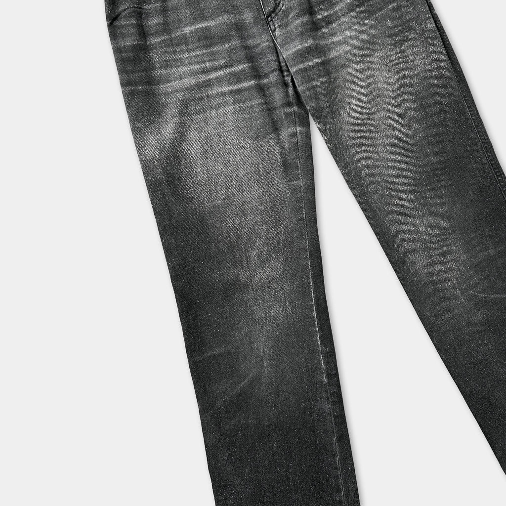 A pair of black jeans with visible wrinkles and creases, suggesting they have been worn multiple times.
