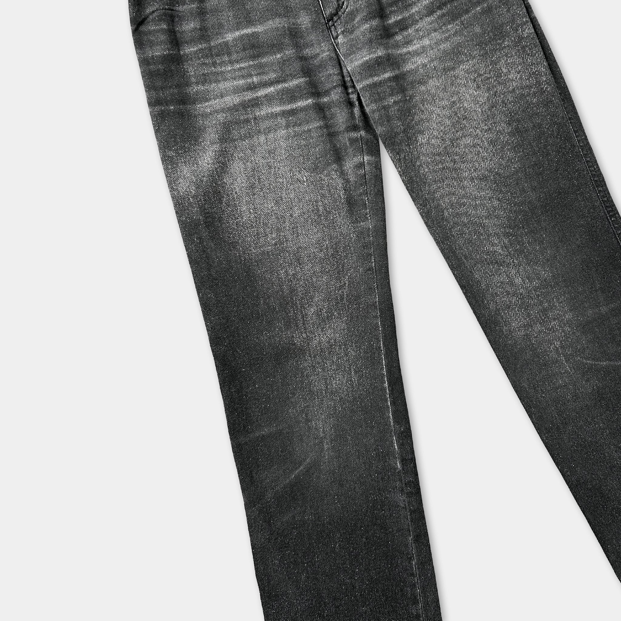 A pair of black jeans with visible wrinkles and creases, suggesting they have been worn multiple times.