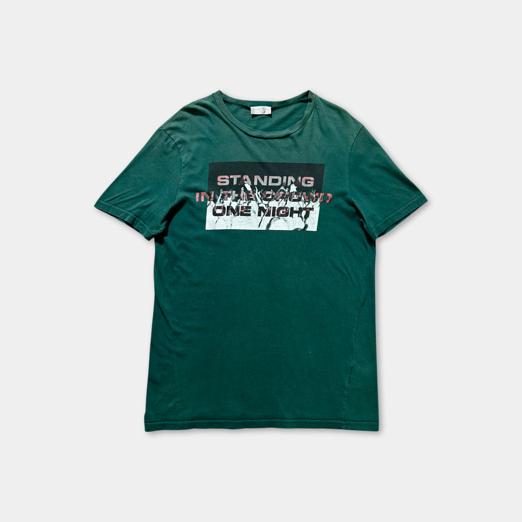 A green t-shirt with a graphic design featuring text and graphics.