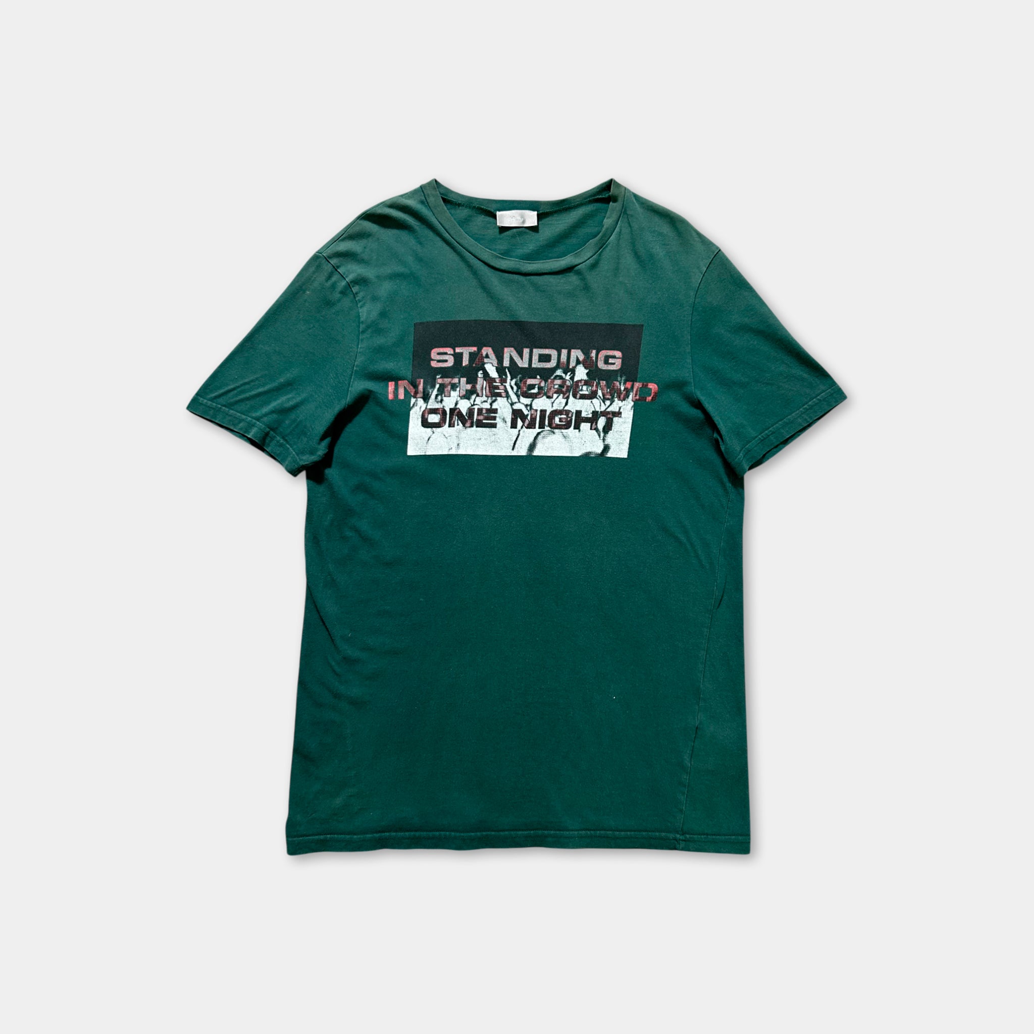 A green t-shirt with a graphic design featuring text and graphics.