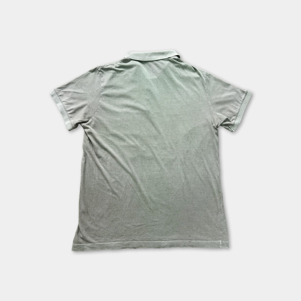 a gray polo shirt laid flat on a white background.
