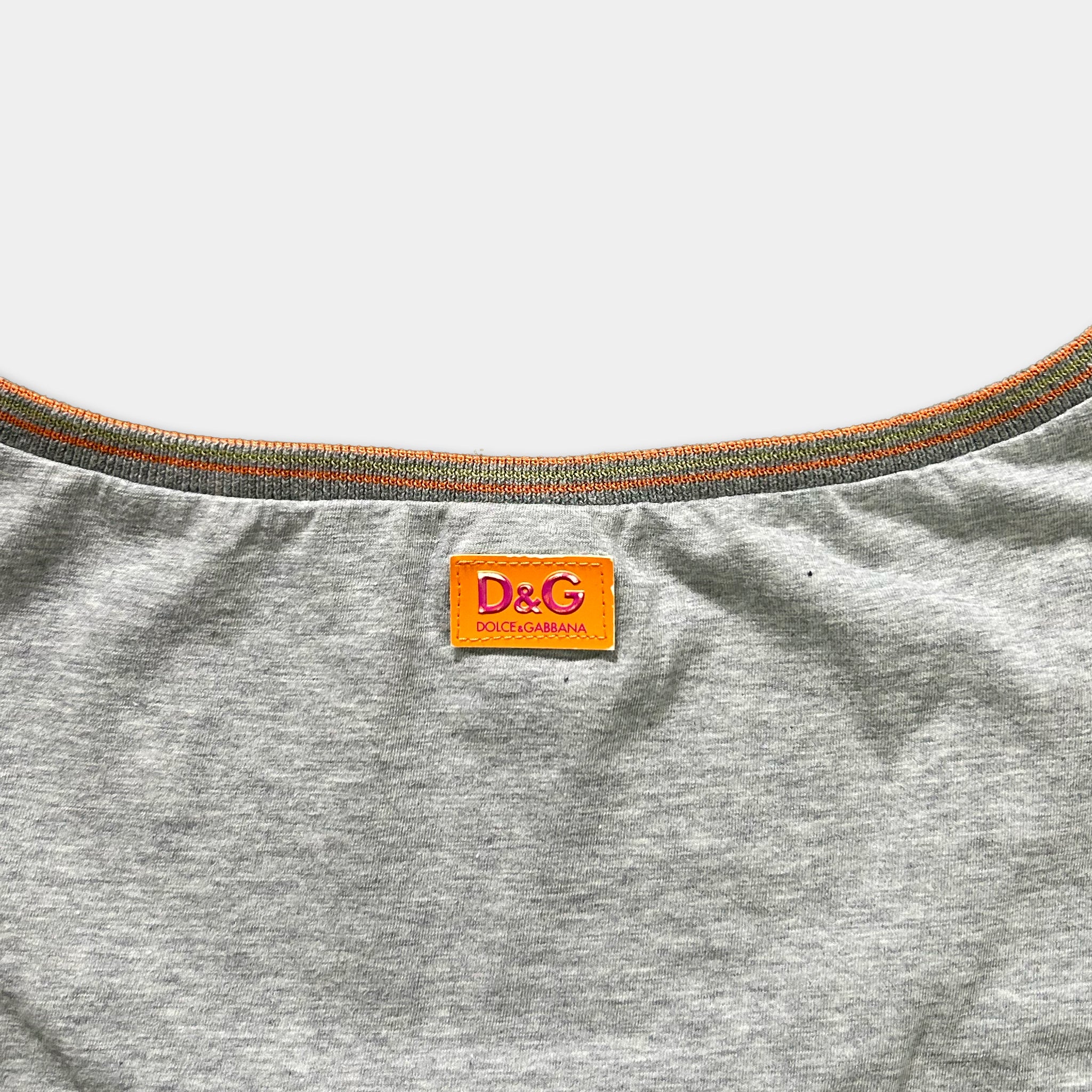 A gray T-shirt with a red and orange D&G logo on the collar.