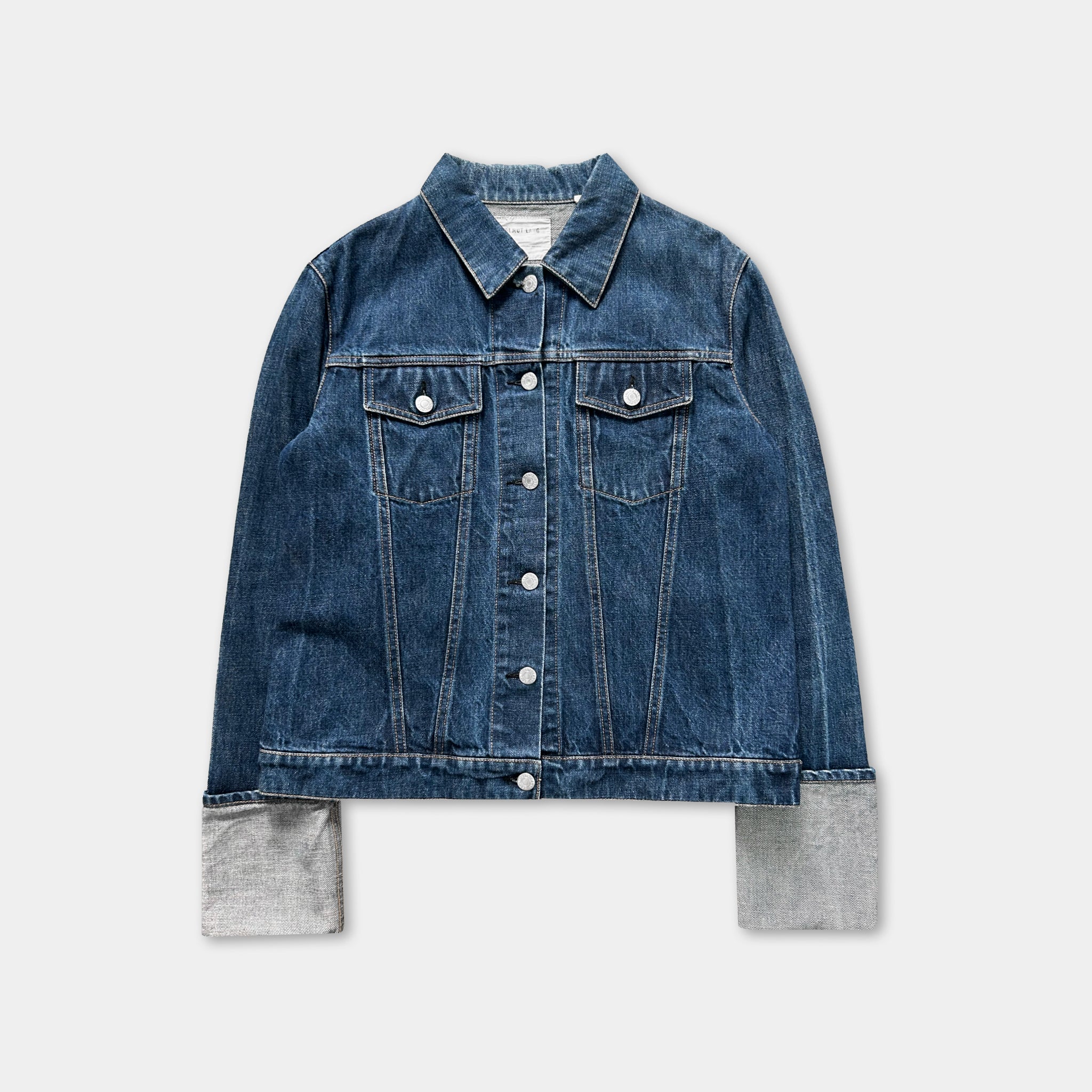 A denim jacket with a button-down front and two pockets, displayed against a white background.