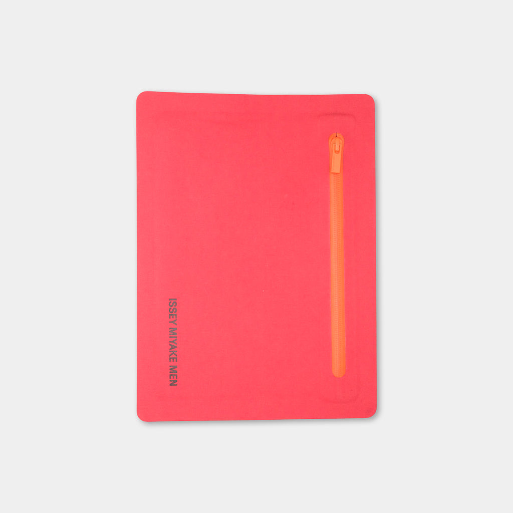 A bright red notebook with a zipper on the right side.