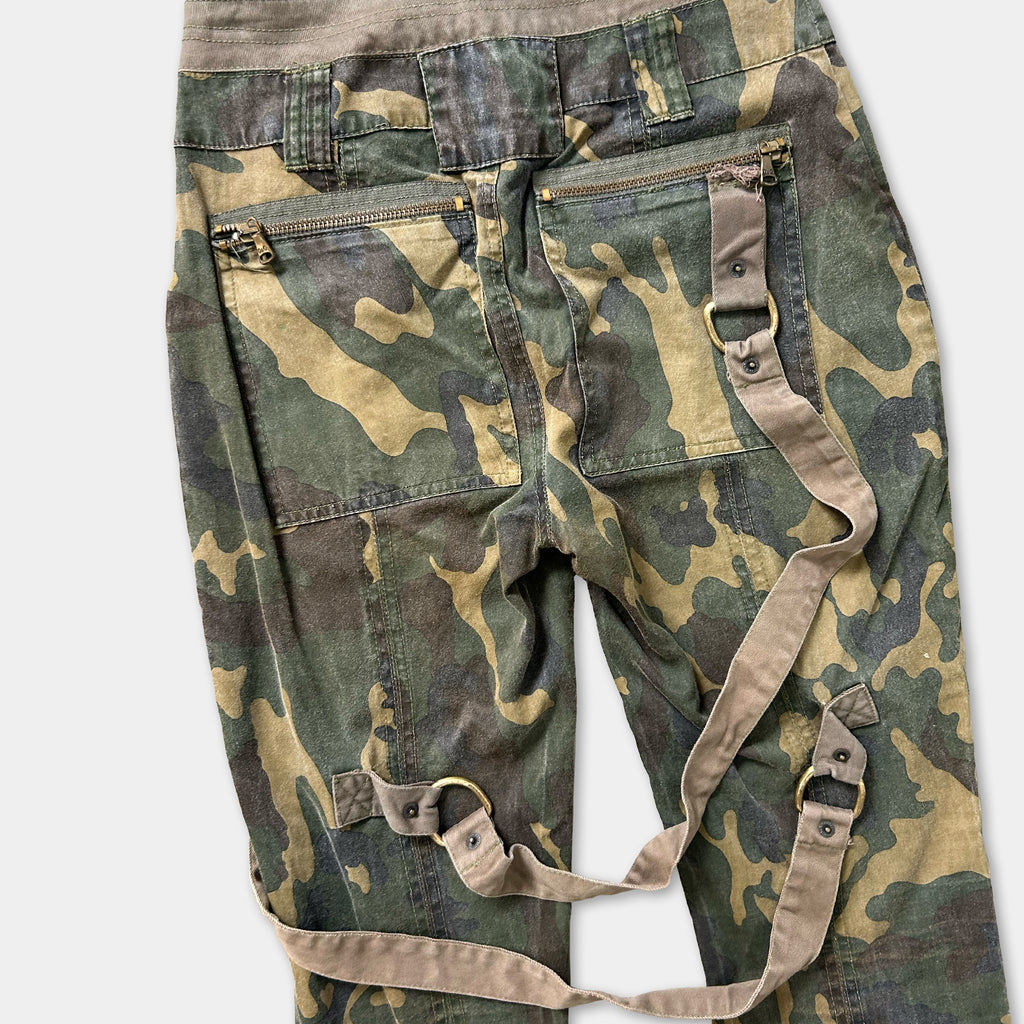 Camouflaged pants with a strap across the waist.