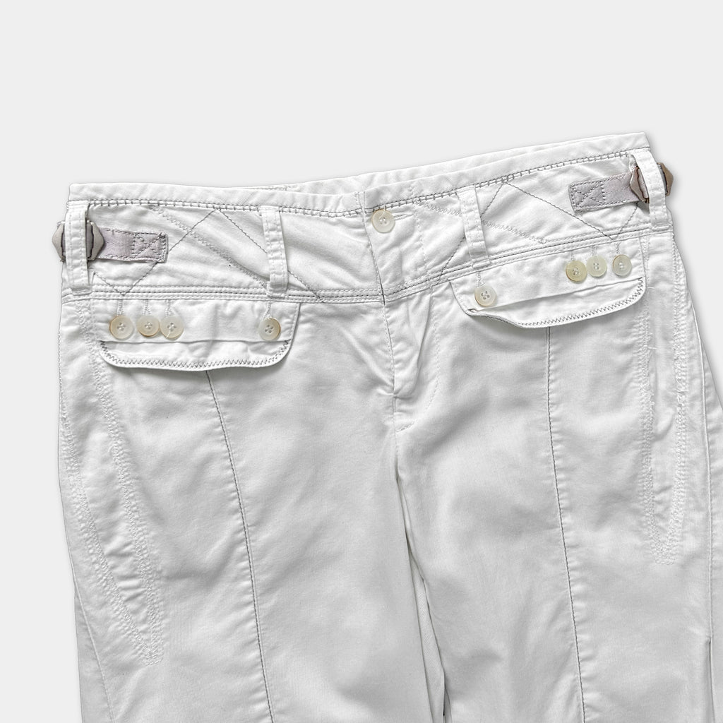 A pair of white pants with a zipper and button closure.