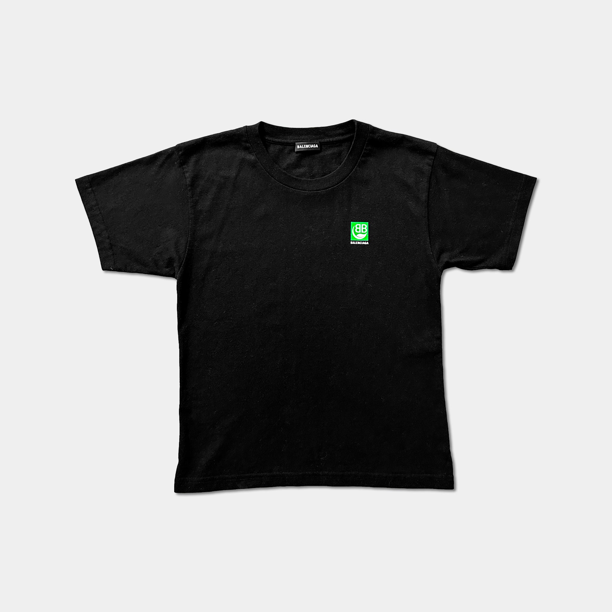 A black t-shirt with a small green logo on the left side.