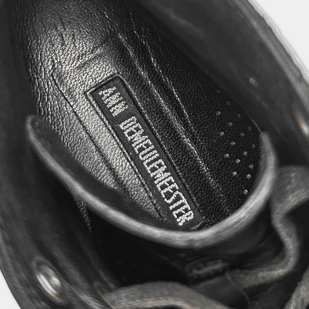 the interior of a black shoe, specifically the sole and the laces.