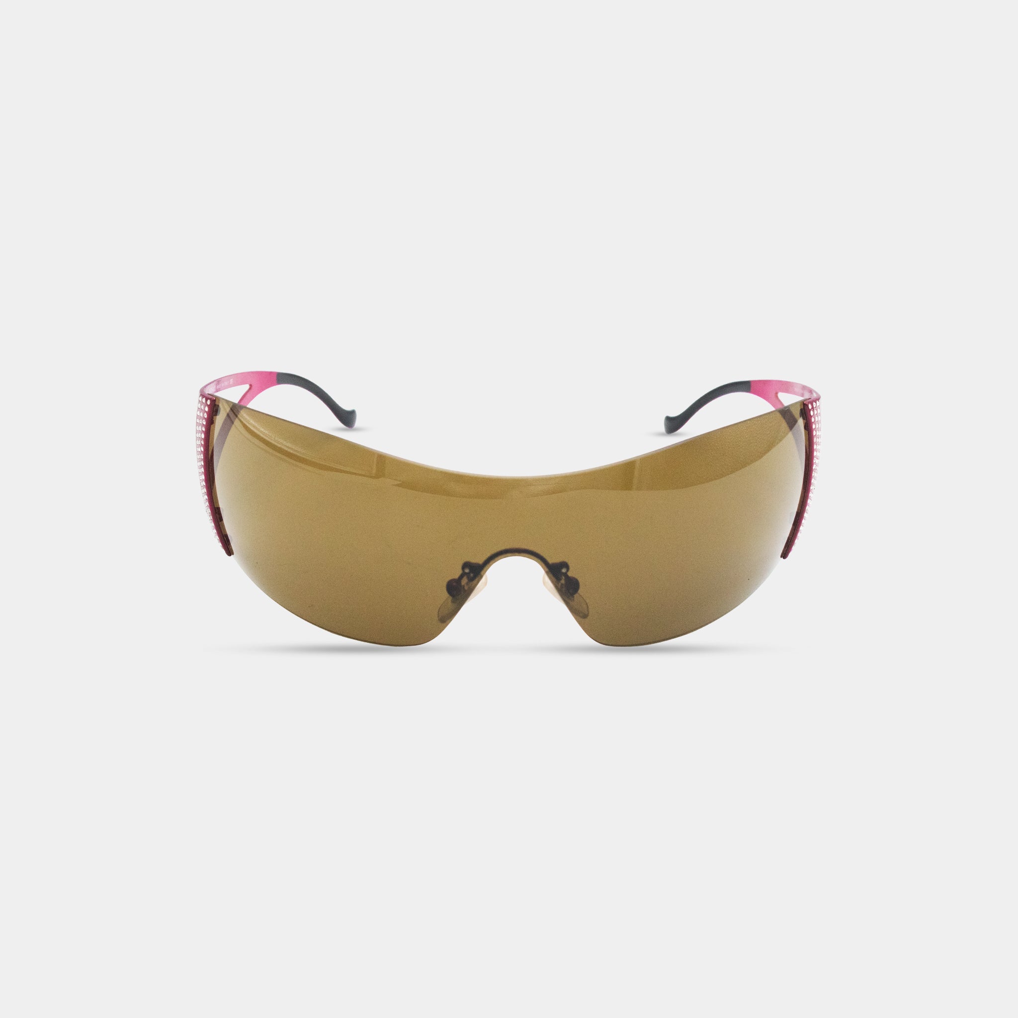 A pair of brown sunglasses with pink accents, featuring a curved frame and dark lenses.