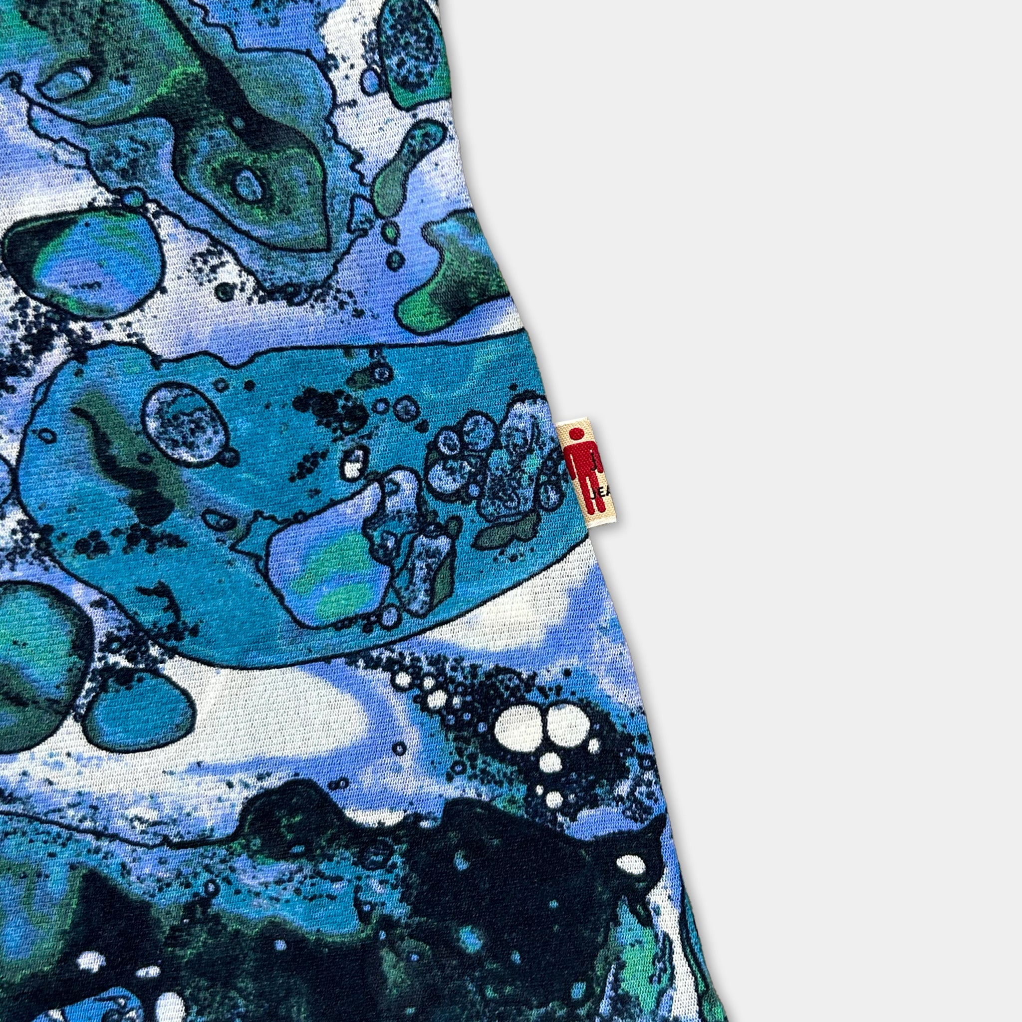 a close-up view of a colorful, abstract pattern with various shapes and colors, including shades of blue, green, and white.