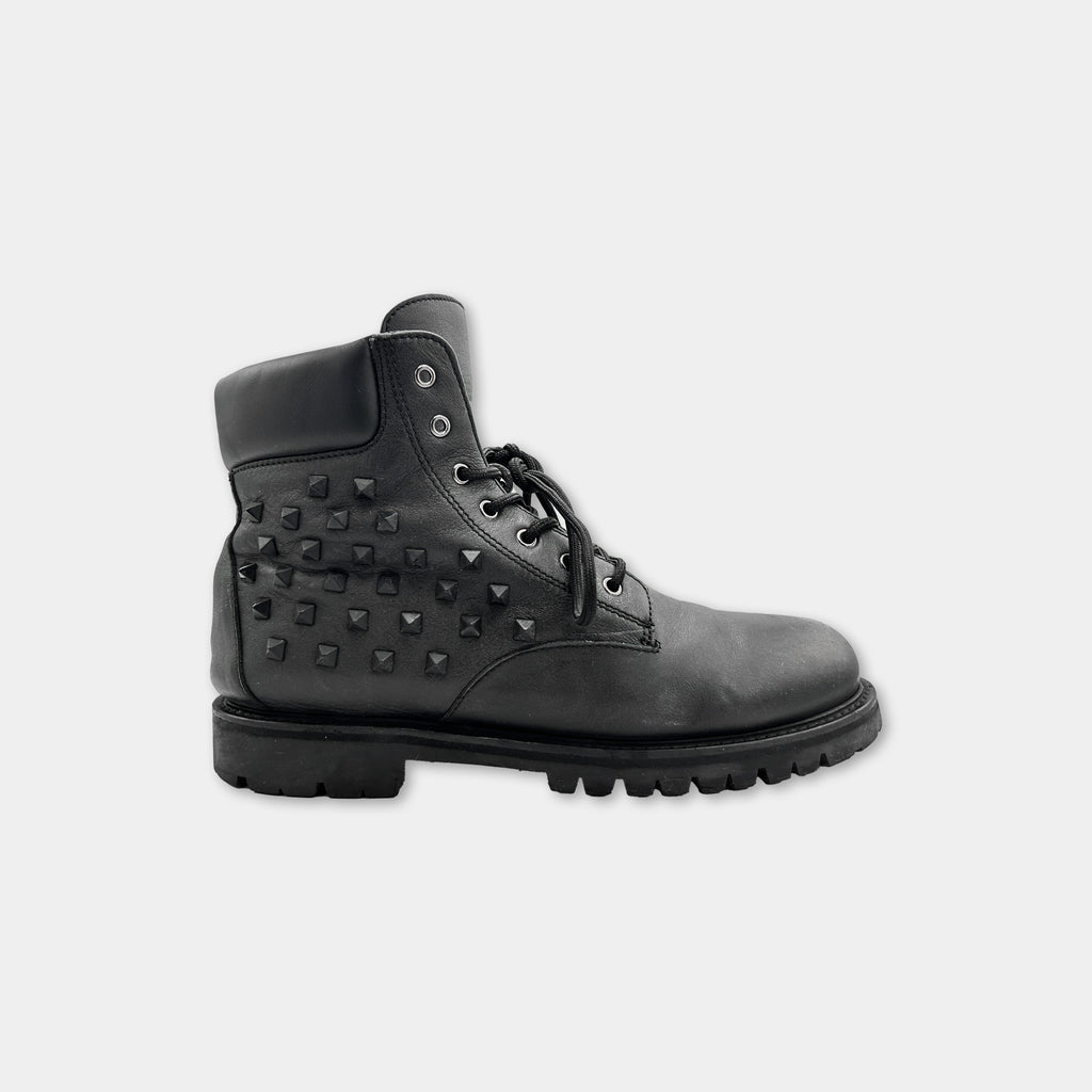 A black leather boot with studded details on the side.