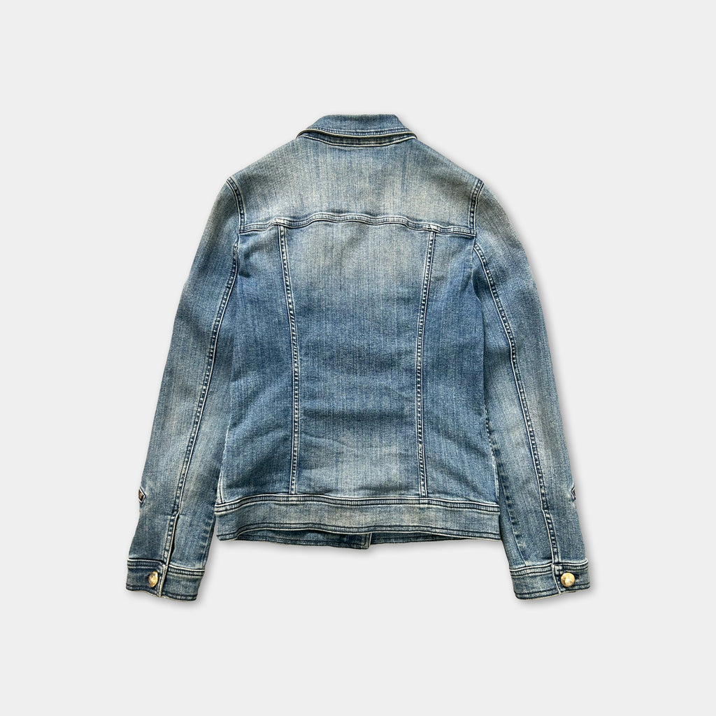 A denim jacket with a classic button-down front and long sleeves, displayed against a plain background.