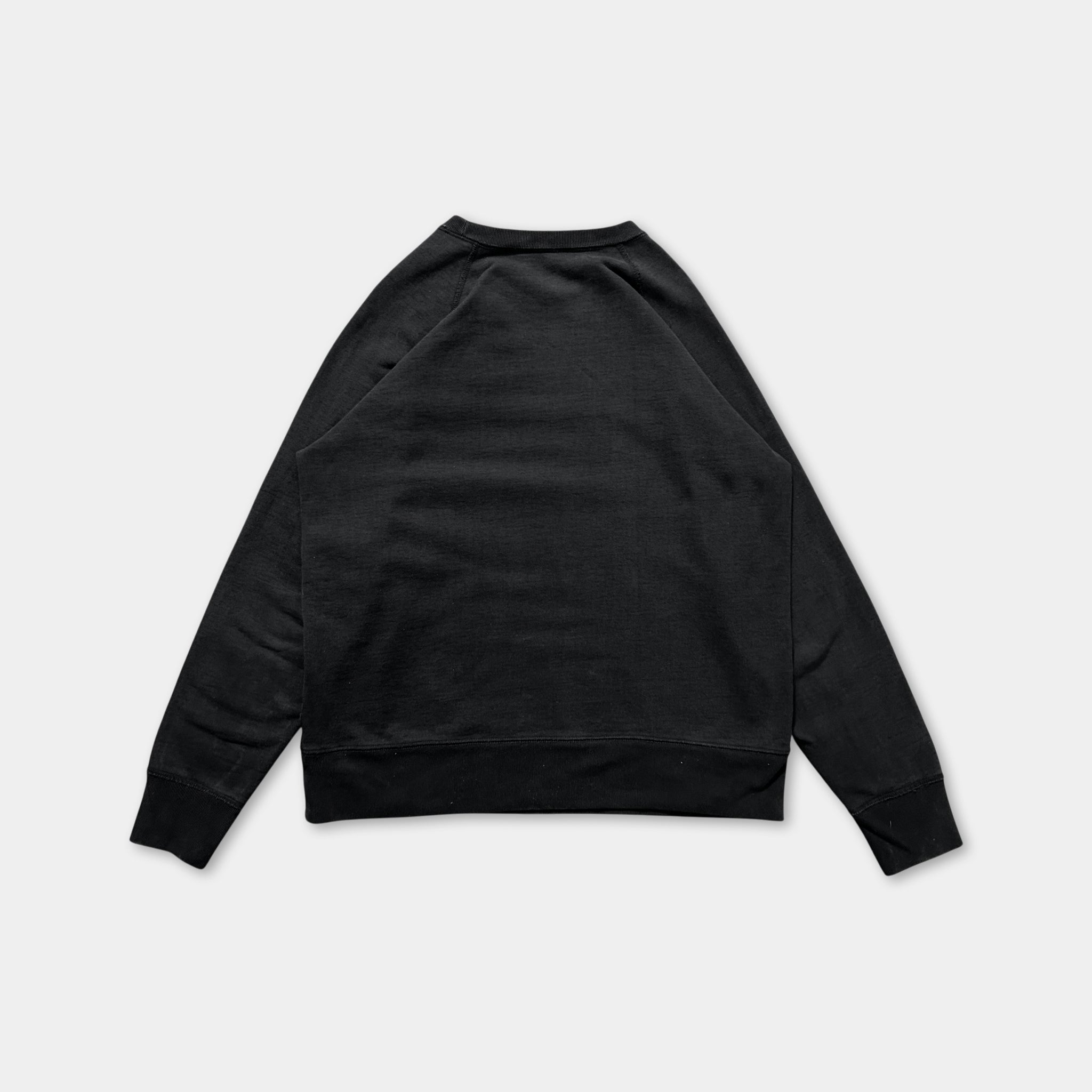 A black sweatshirt with long sleeves is shown against a white background.