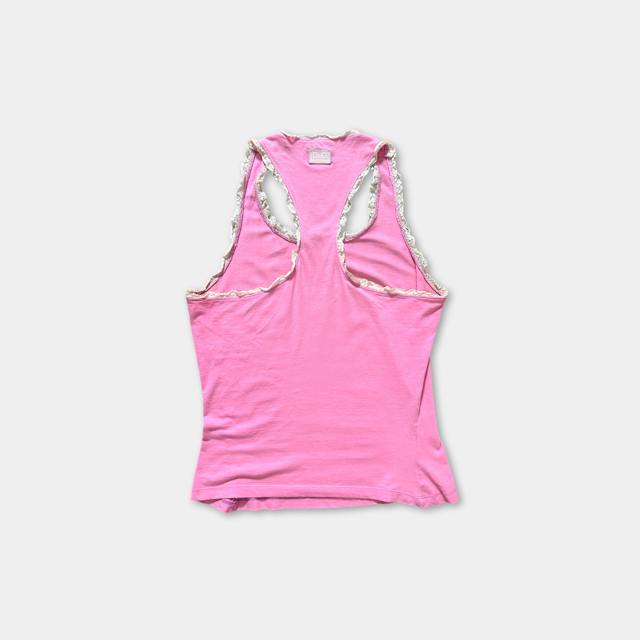 A pink tank top with a high back and two cutouts on the sides.