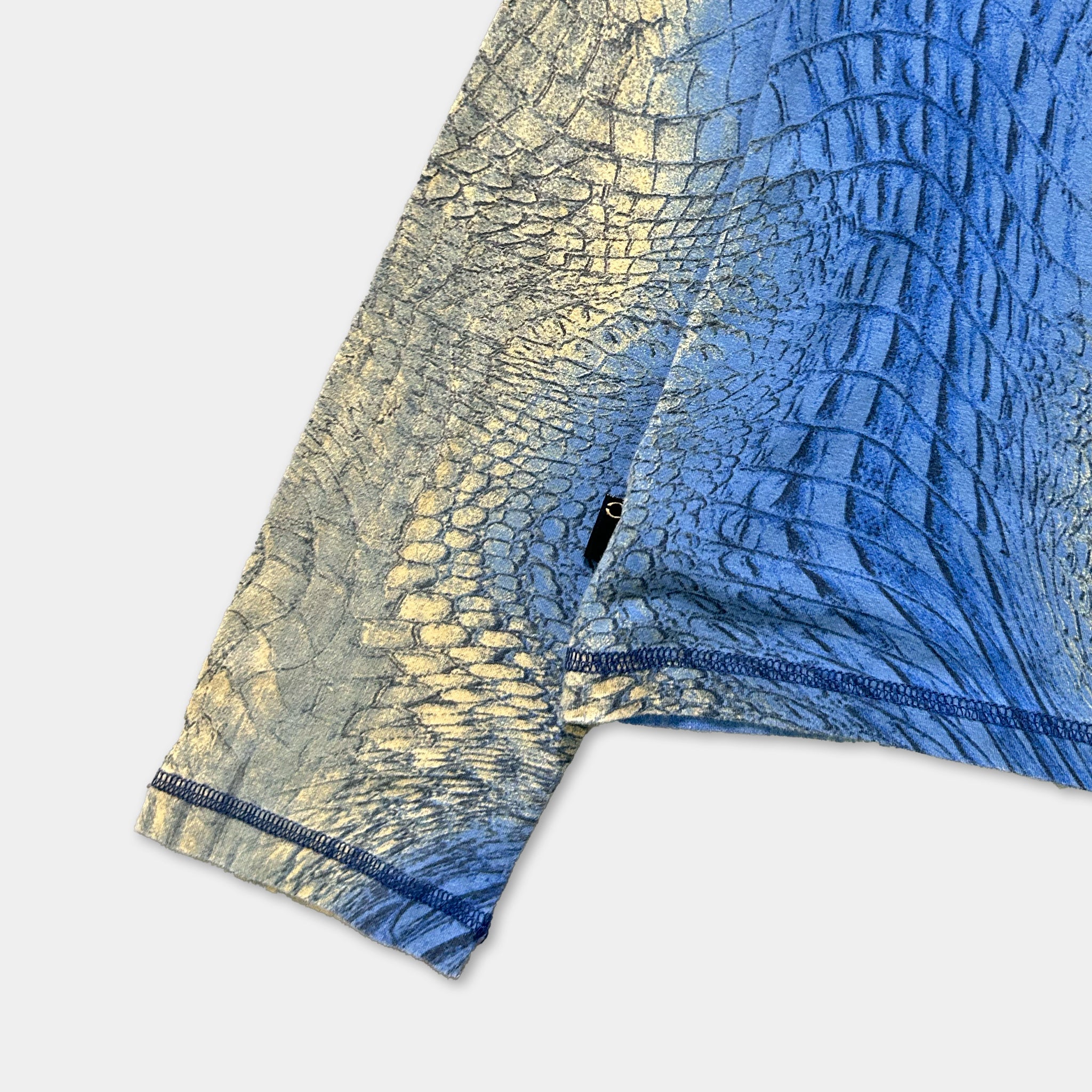 a close-up view of a fabric with a pattern resembling scales or skin, possibly resembling the skin of a crocodile or alligator.