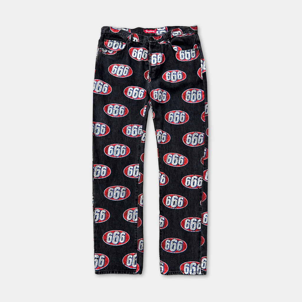 A pair of black jeans with a repeating pattern of the number 666 in red and white.