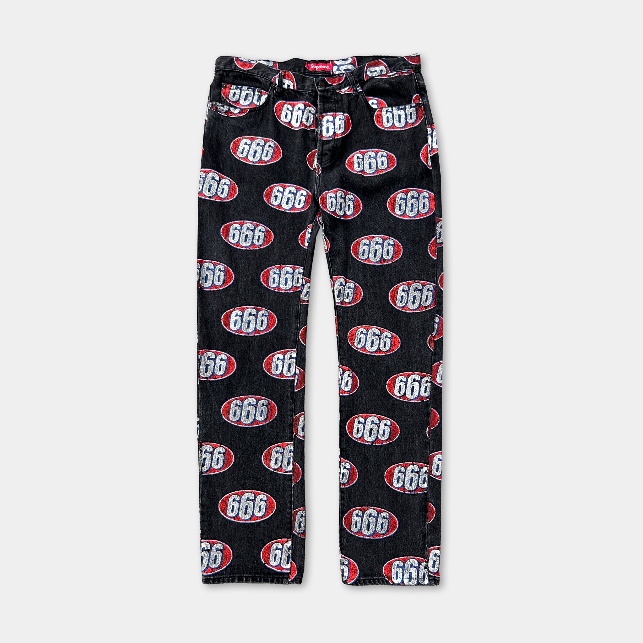 A pair of black jeans with a repeating pattern of the number 666 in red and white.