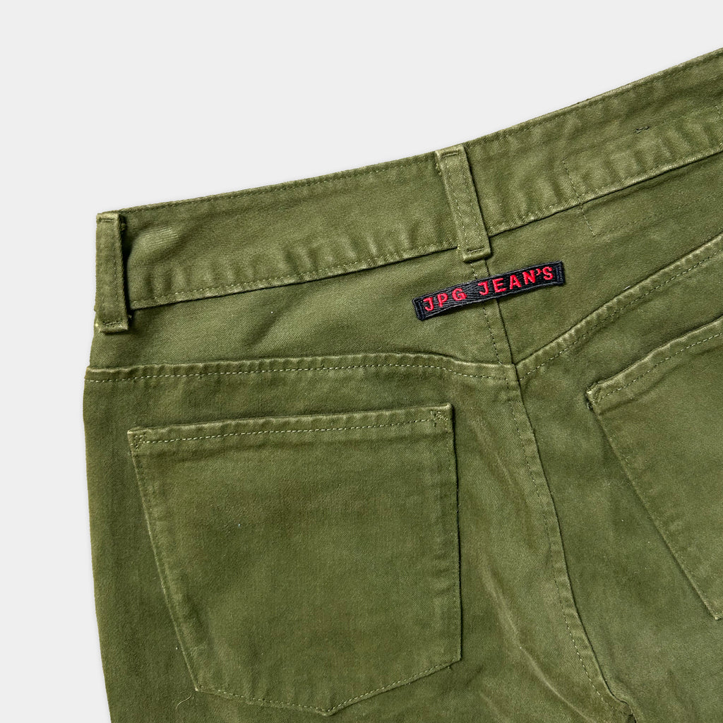 A pair of olive green cargo jeans with a red and black label on the back pocket.