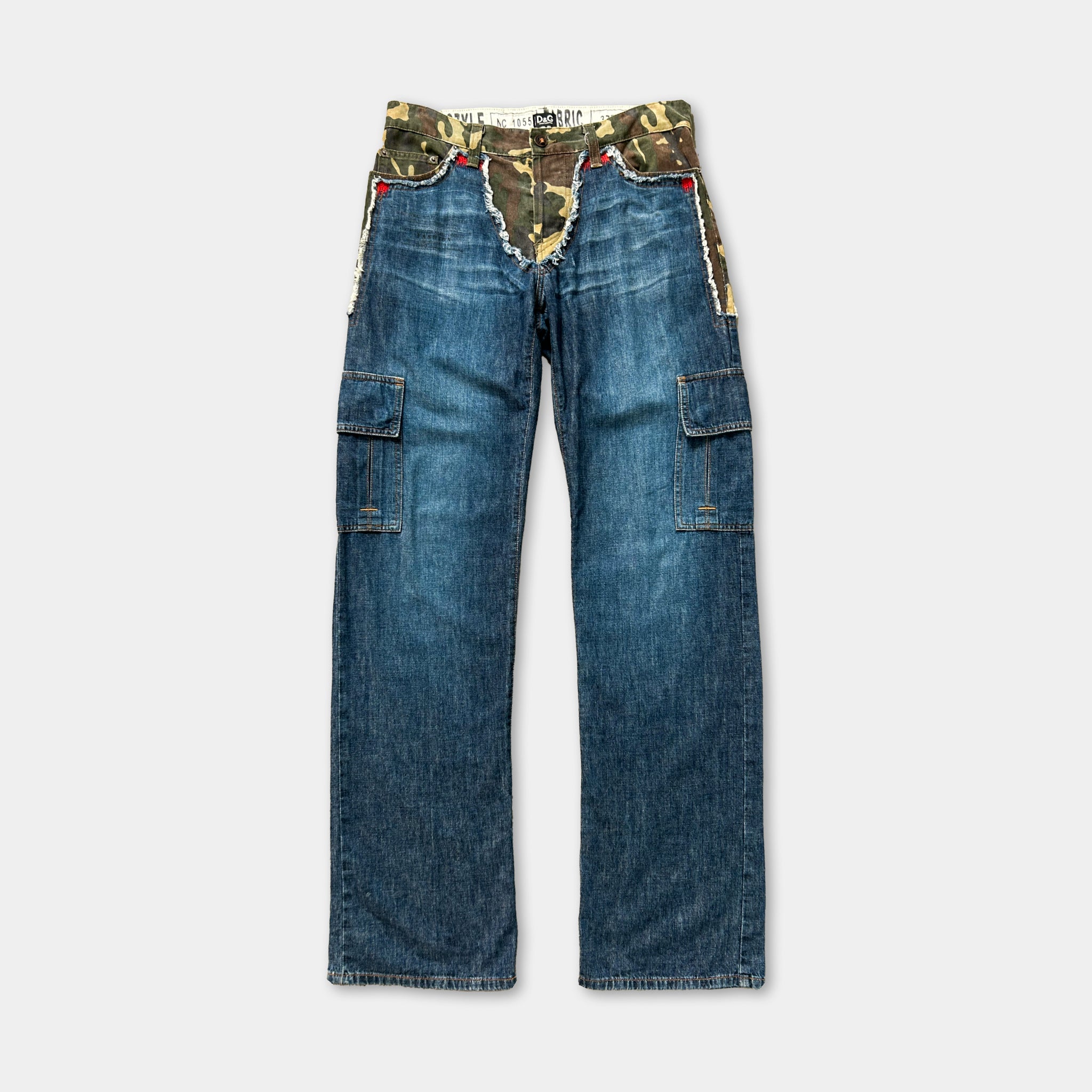 A pair of blue jeans with a camouflage pattern on the waistband and pockets.