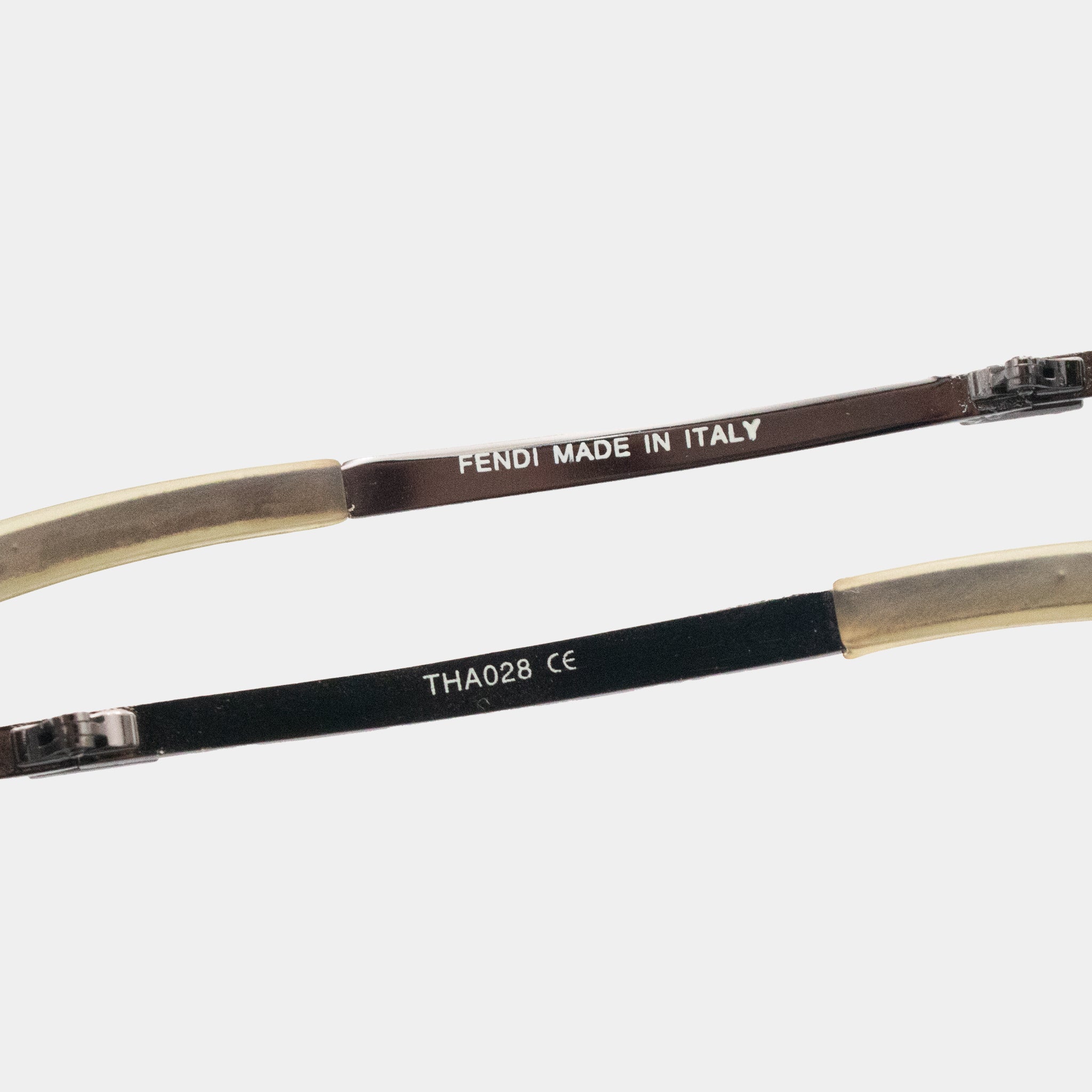a pair of Fendi sunglasses with the text "FENDI MADE IN ITALY" printed on the frame.