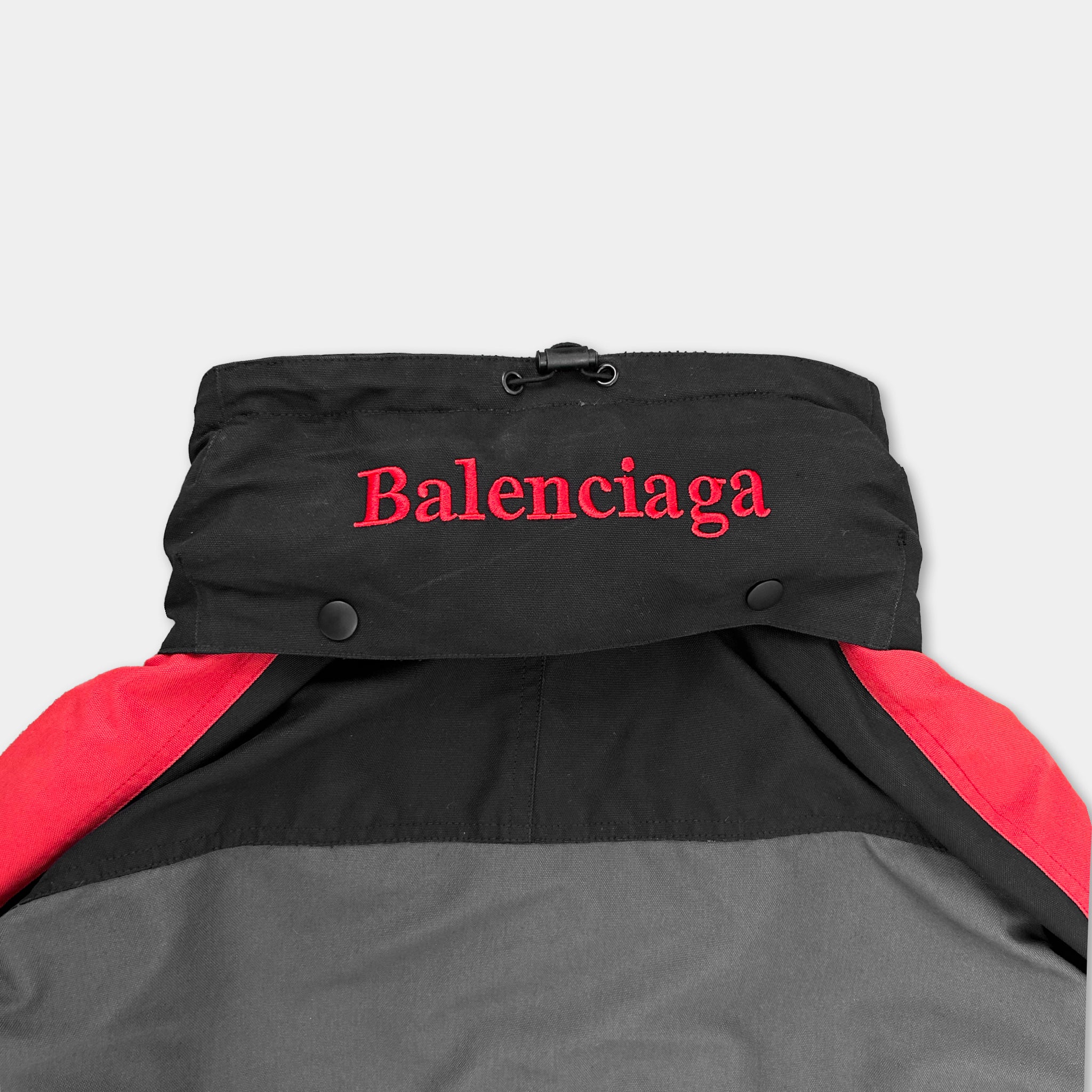A black and red jacket with the word "Balenciaga" printed on it.