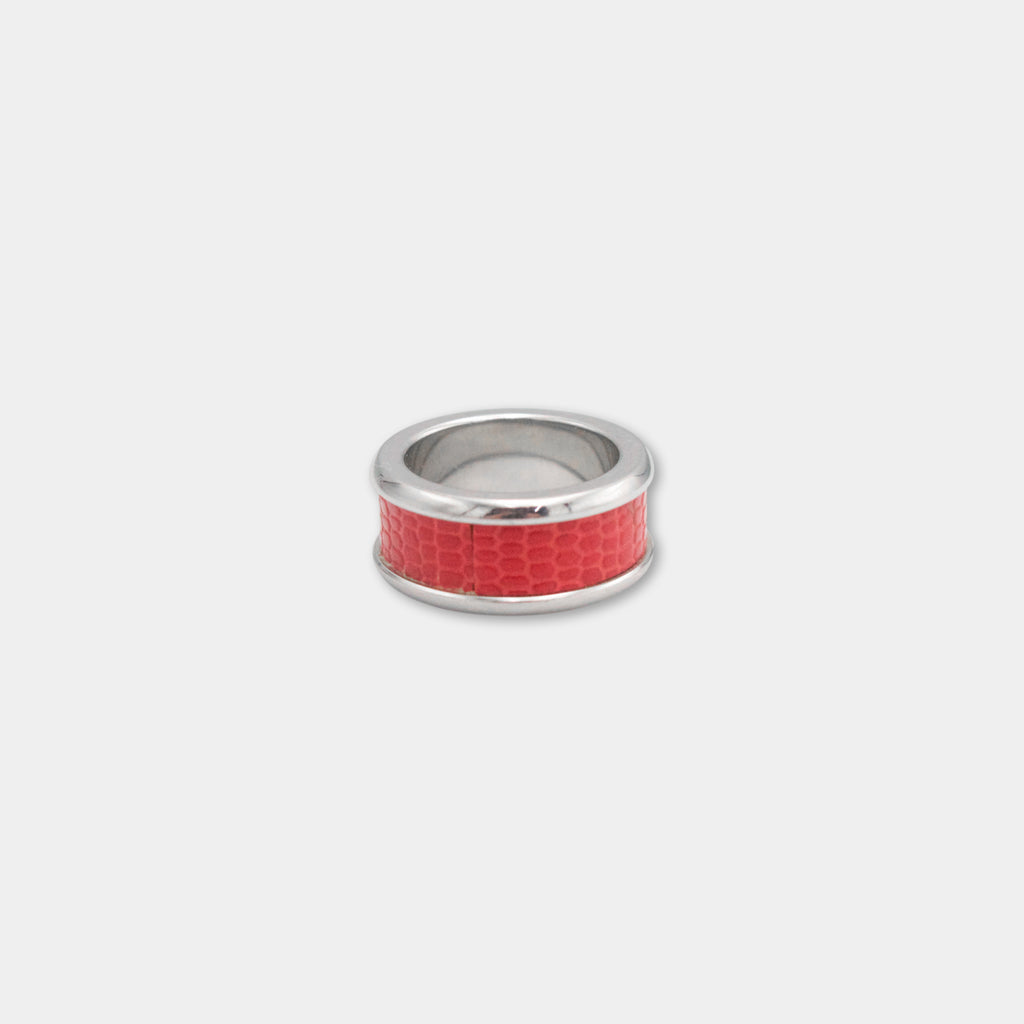 A silver ring with a red, snake-like pattern on the band.