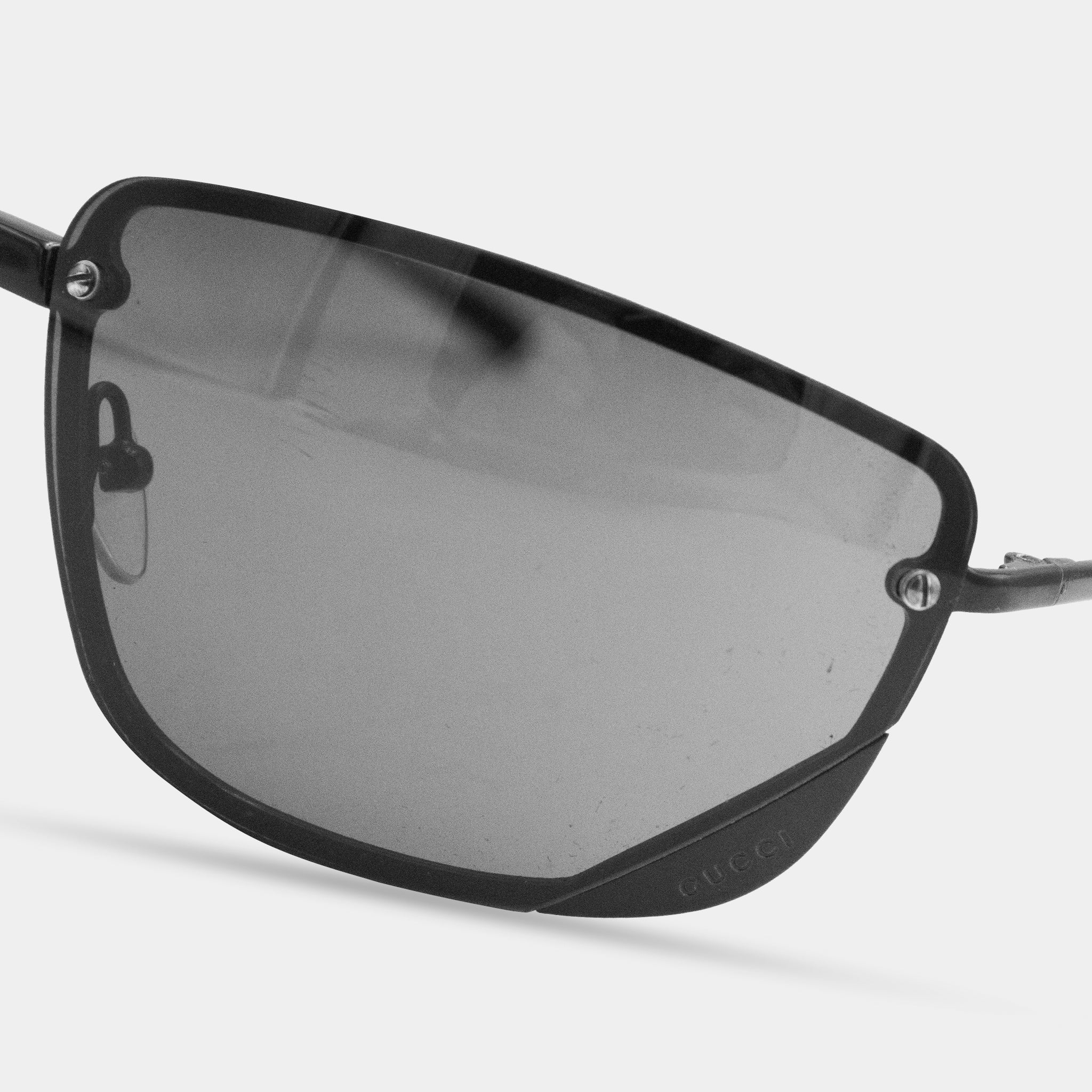 A pair of black-framed sunglasses with a dark lens.