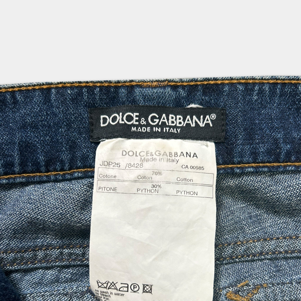 A close-up view of a label on a pair of blue denim jeans, indicating that they are made in Italy by Dolce & Gabbana.