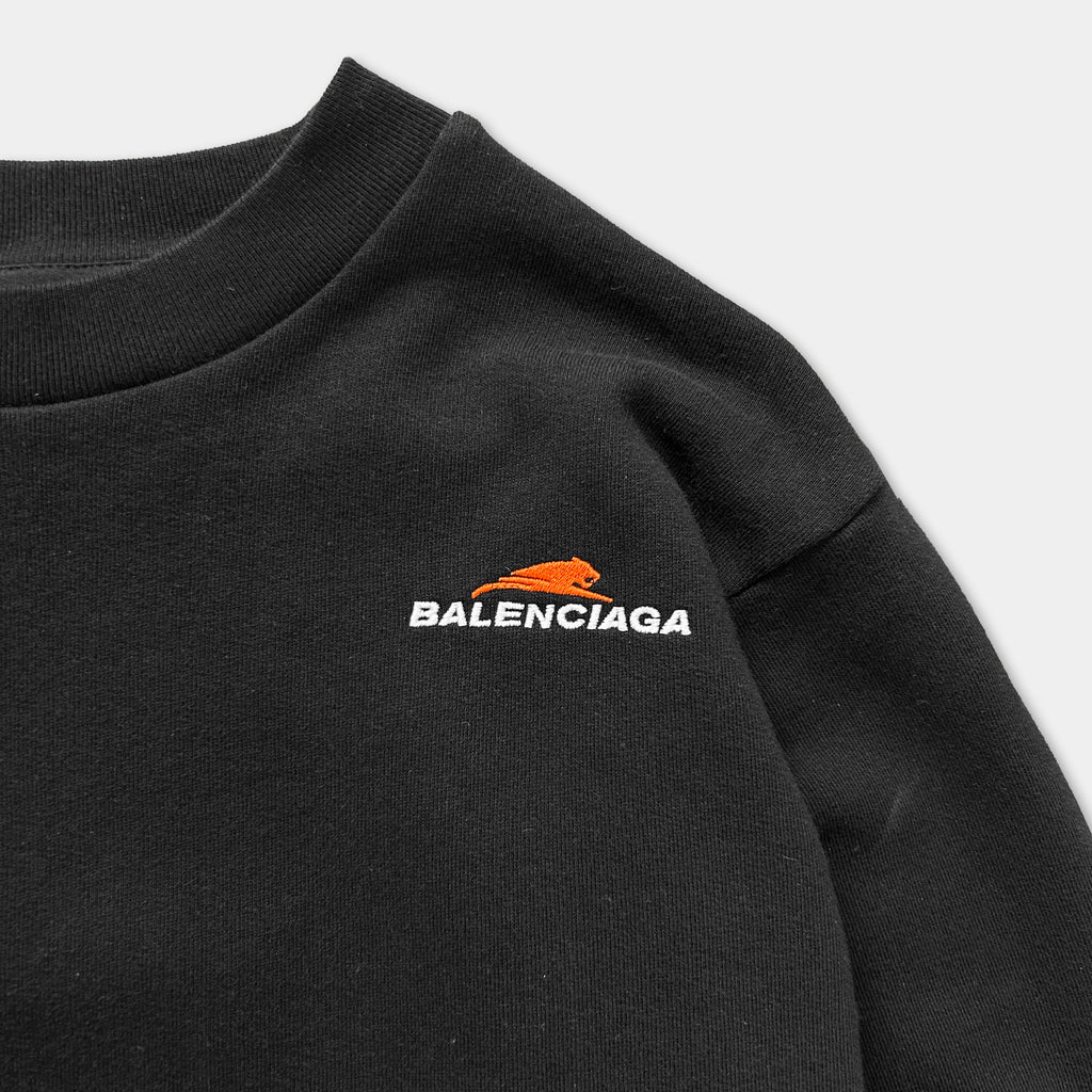 A black sweater with the Balenciaga logo printed on the front.
