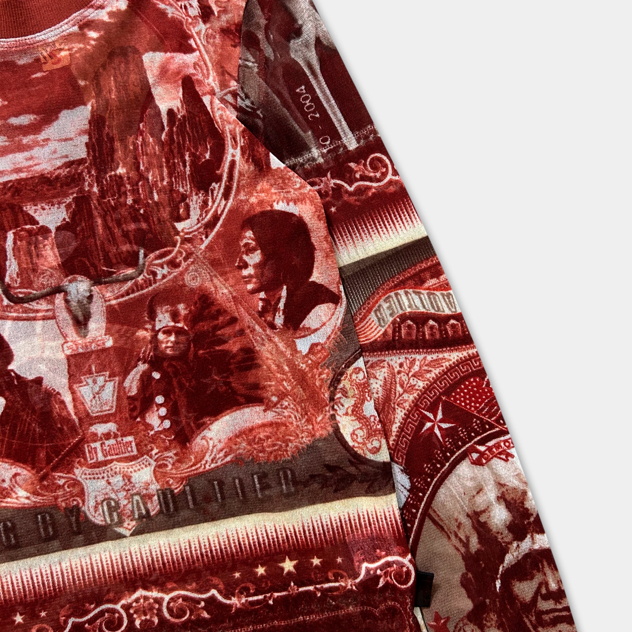 The image is a close-up of a red and white patterned fabric, featuring a variety of images and designs.