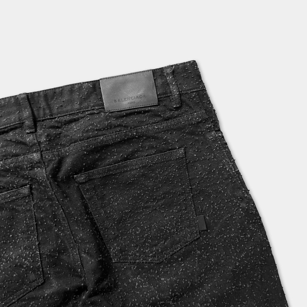 a pair of black jeans with a label on the back pocket.