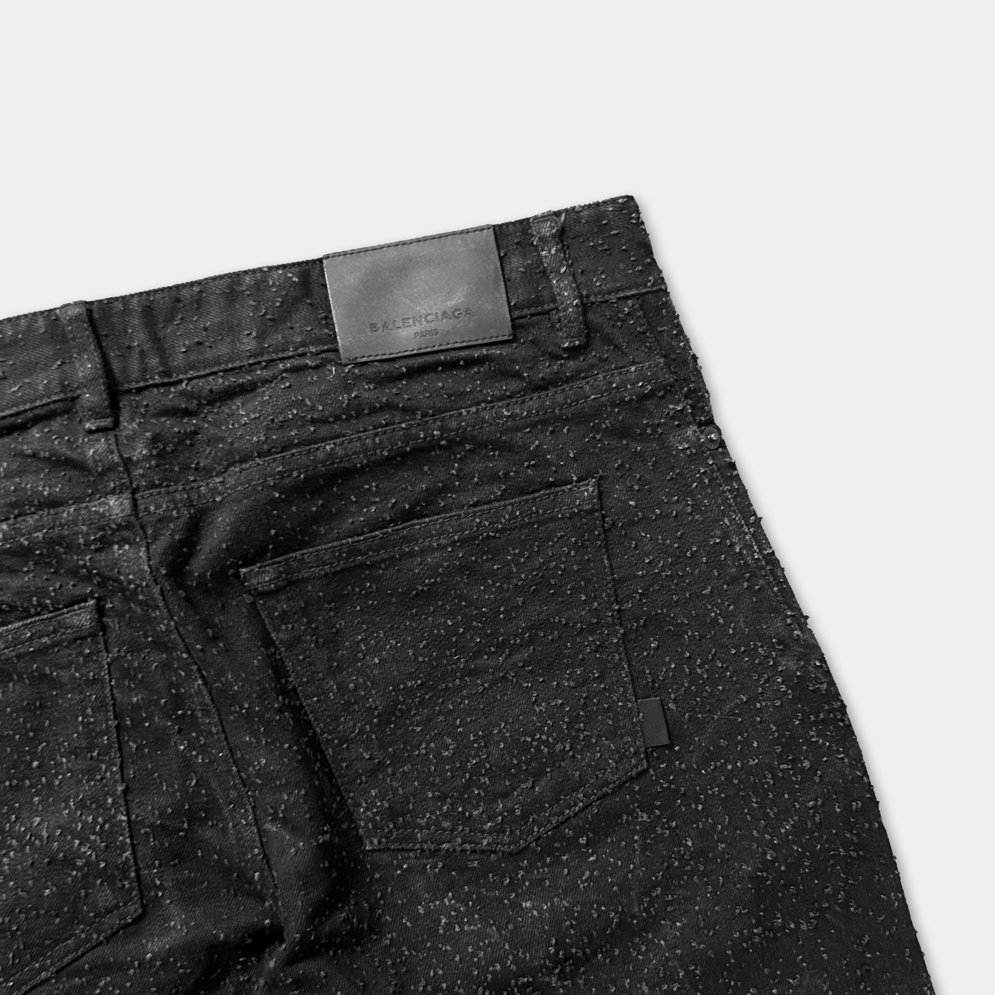a pair of black jeans with a label on the back pocket.