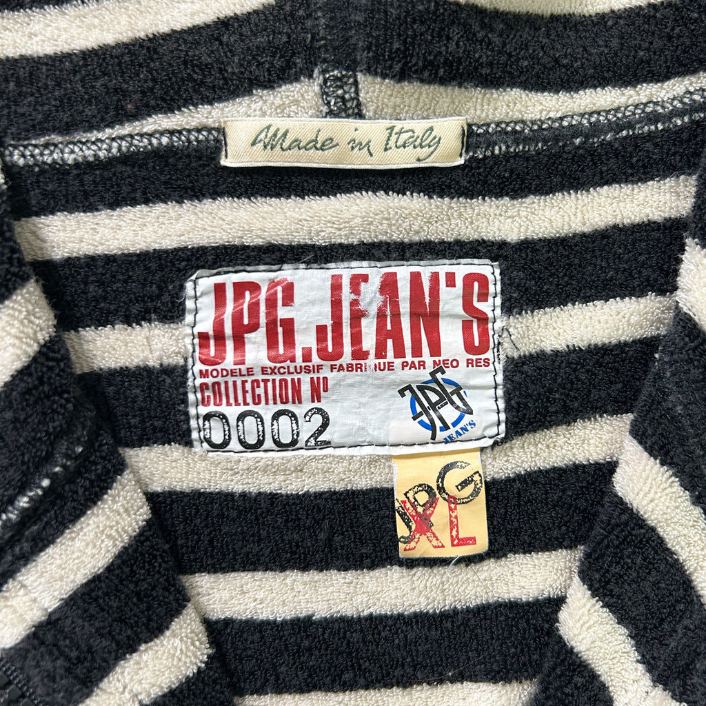 a close-up view of a black and white striped sweater, with a label on the collar that reads "Made in Italy".