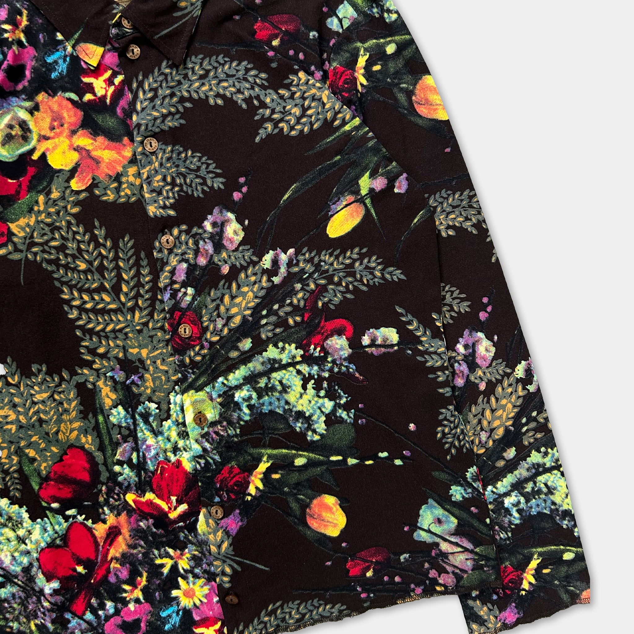 a close-up view of a black fabric with a vibrant, colorful floral pattern.