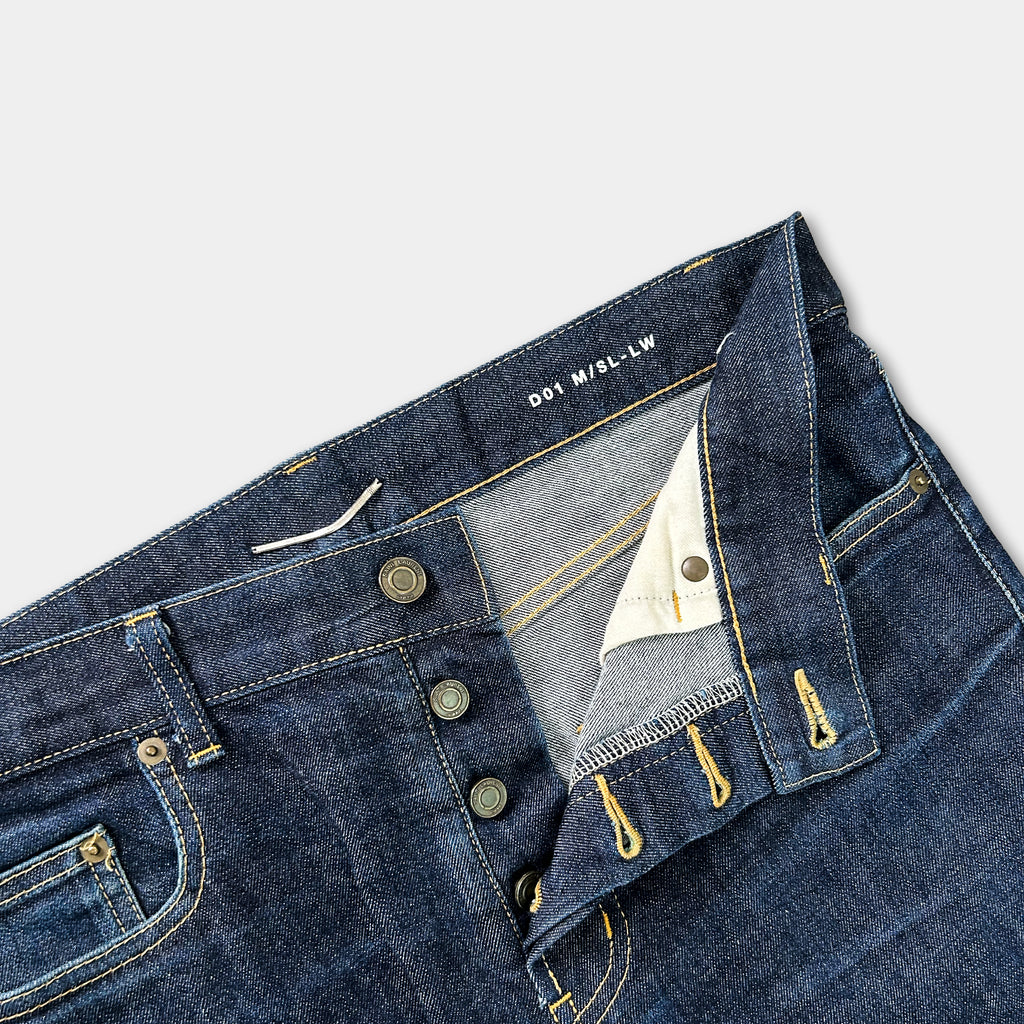 A pair of blue jeans with the label "D01 M-LW" visible on the waistband.