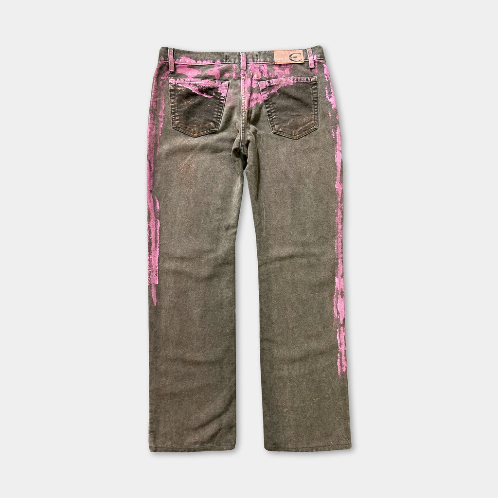 A pair of gray jeans with pink streaks on the sides.