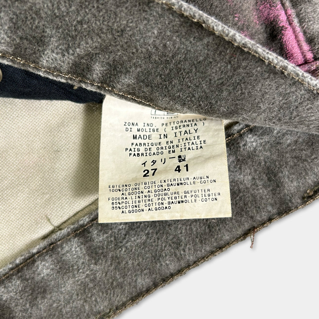 a close-up view of a label on a piece of clothing, likely a pair of jeans or pants, with text providing information about the garment.