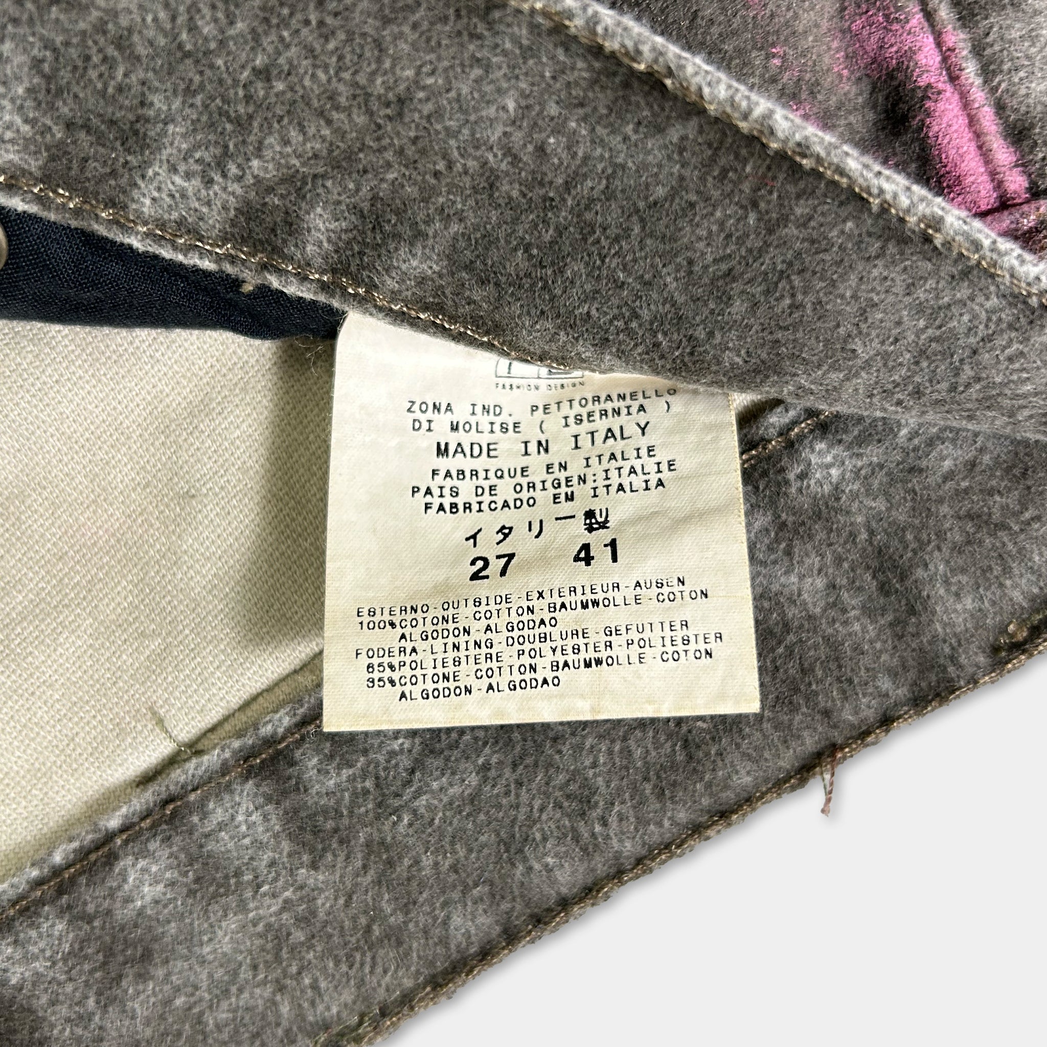a close-up view of a label on a piece of clothing, likely a pair of jeans or pants, with text providing information about the garment.