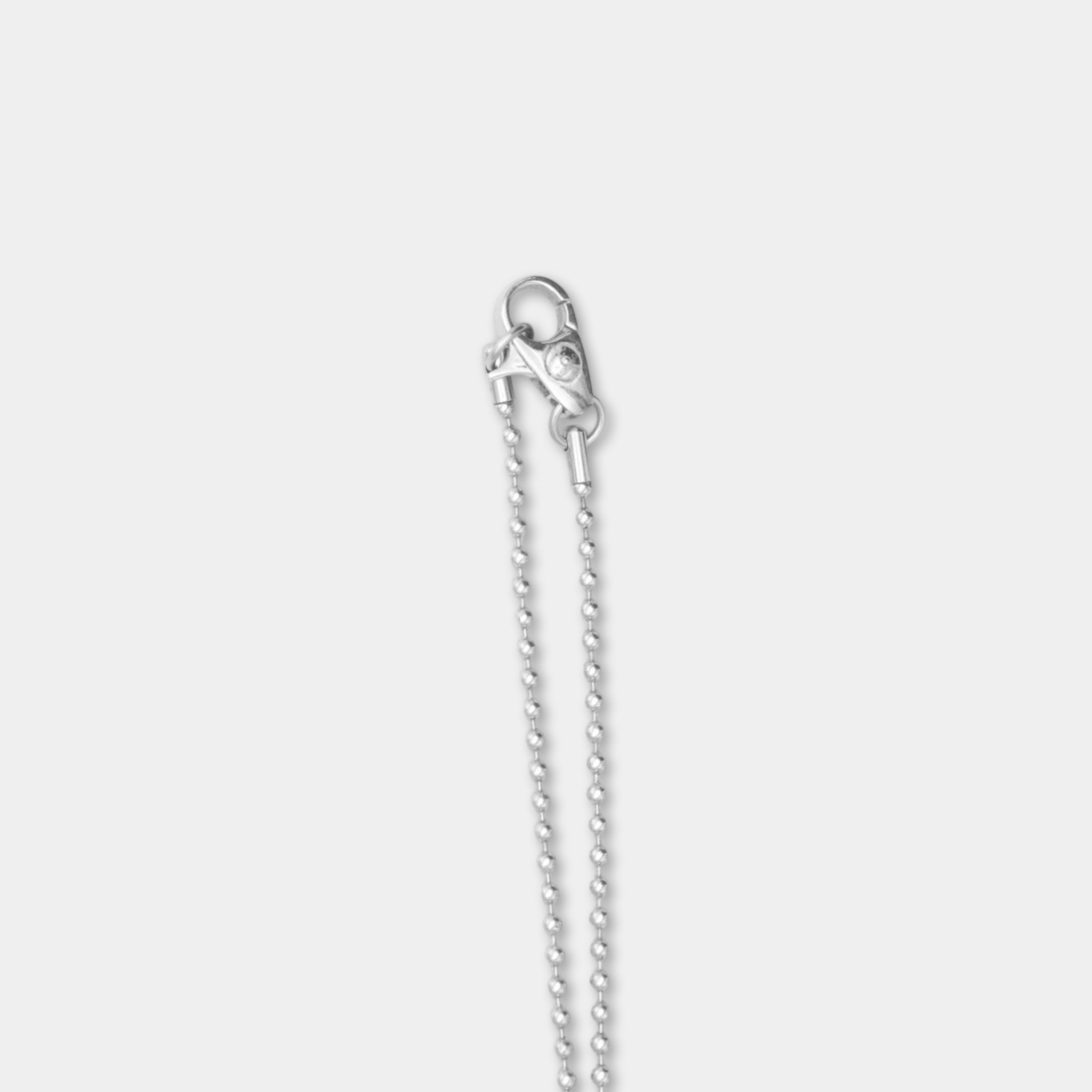 A silver necklace with a clasp and a chain of small silver beads.