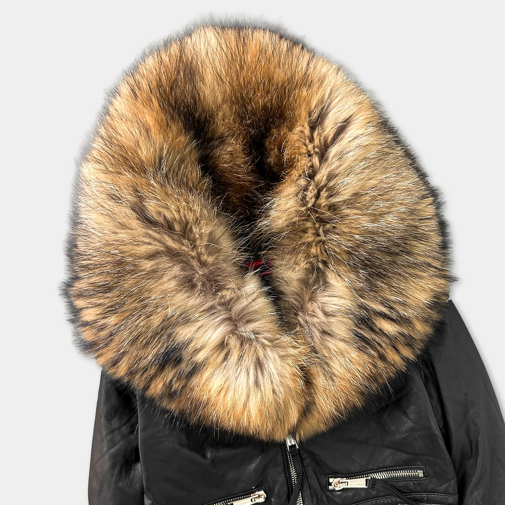 A close-up image of a black fur-trimmed jacket with a large fur collar.