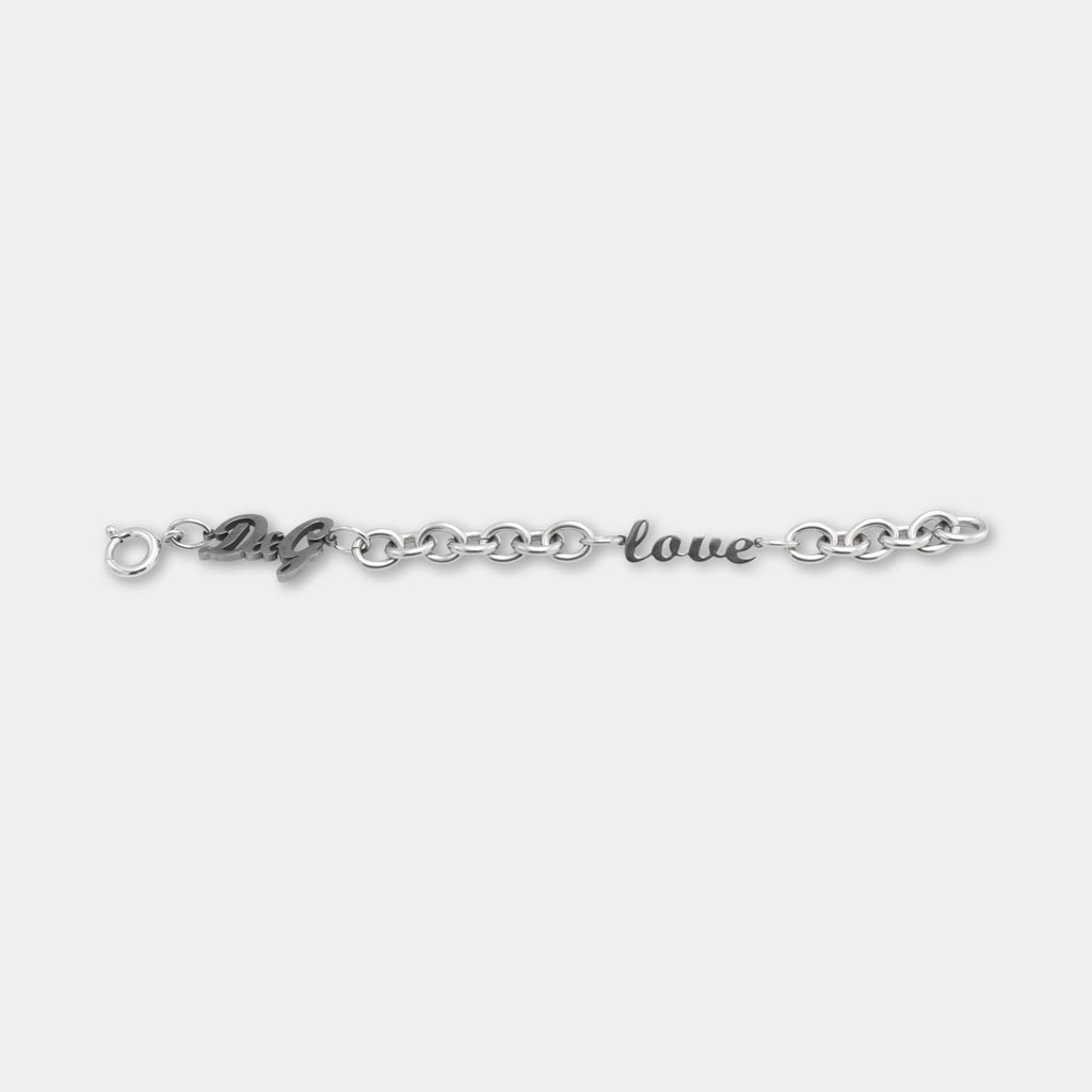 A silver bracelet with the words "love" engraved on it.