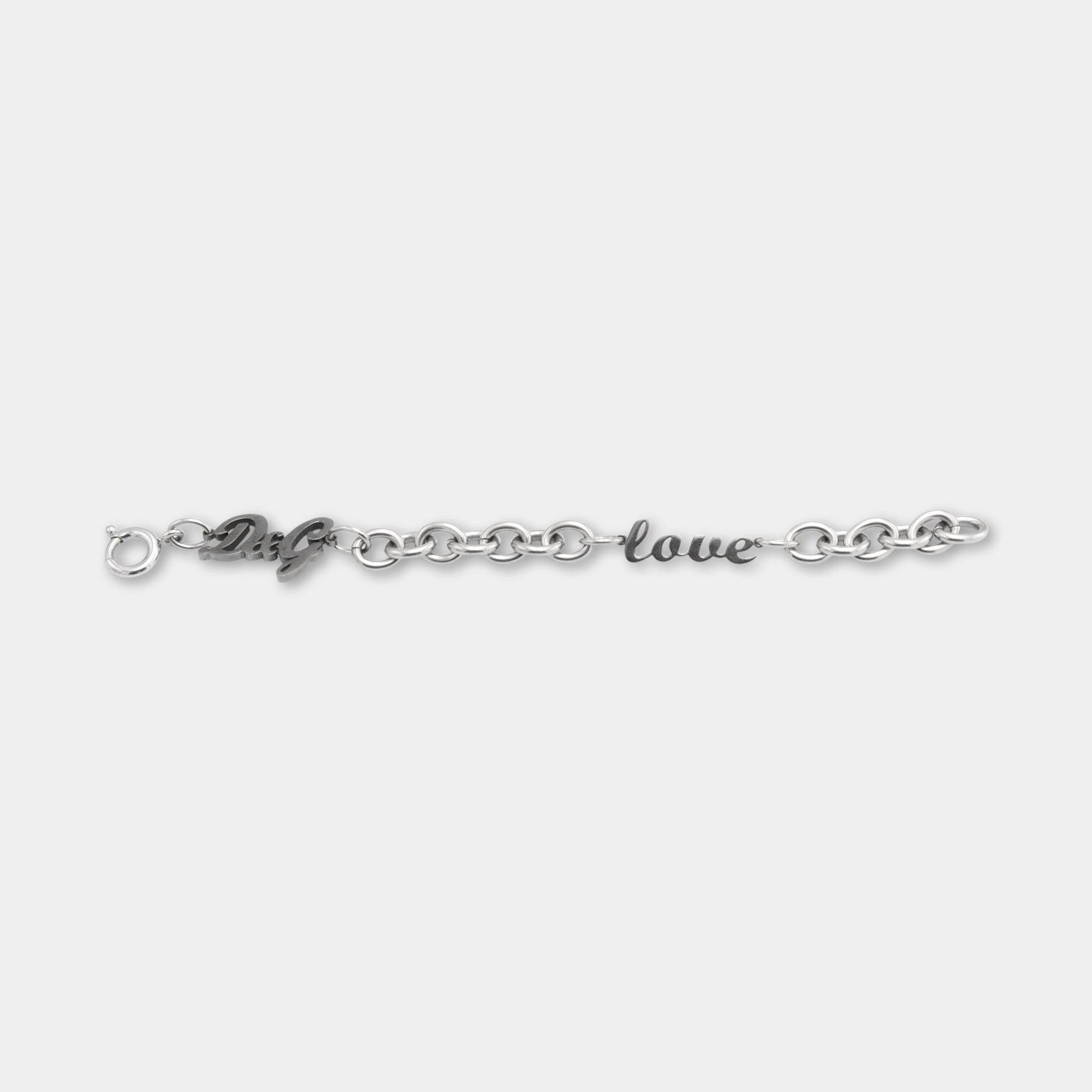 A silver bracelet with the words "love" engraved on it.