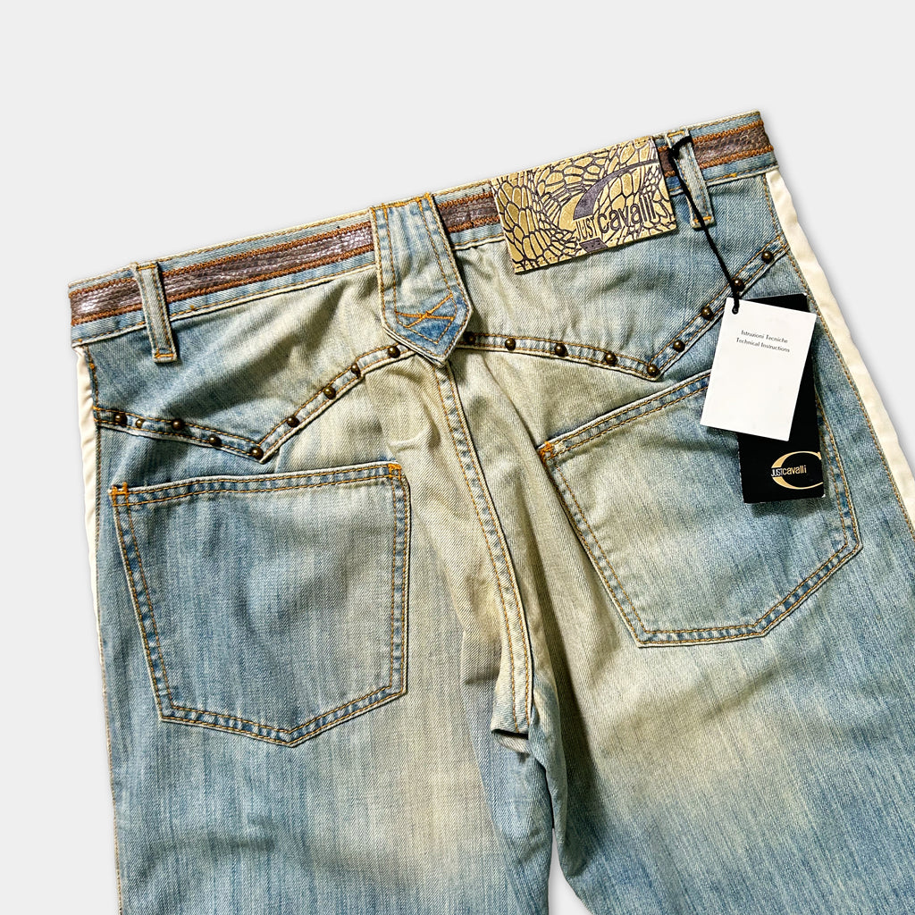 A pair of blue denim jeans with a label attached to the waistband.