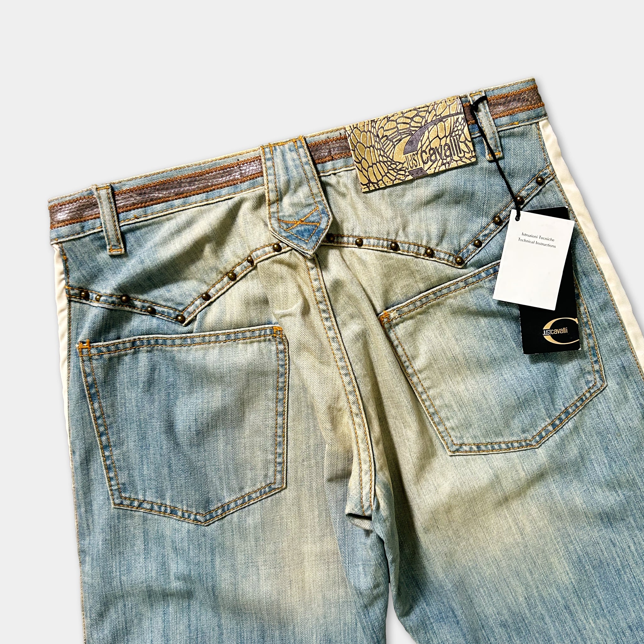 A pair of blue denim jeans with a label attached to the waistband.