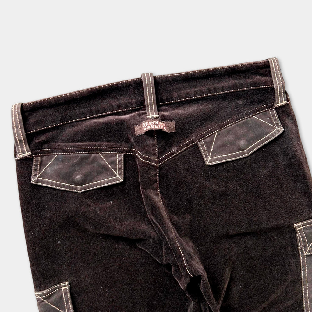 A pair of dark brown velvet pants with a label on the waistband.