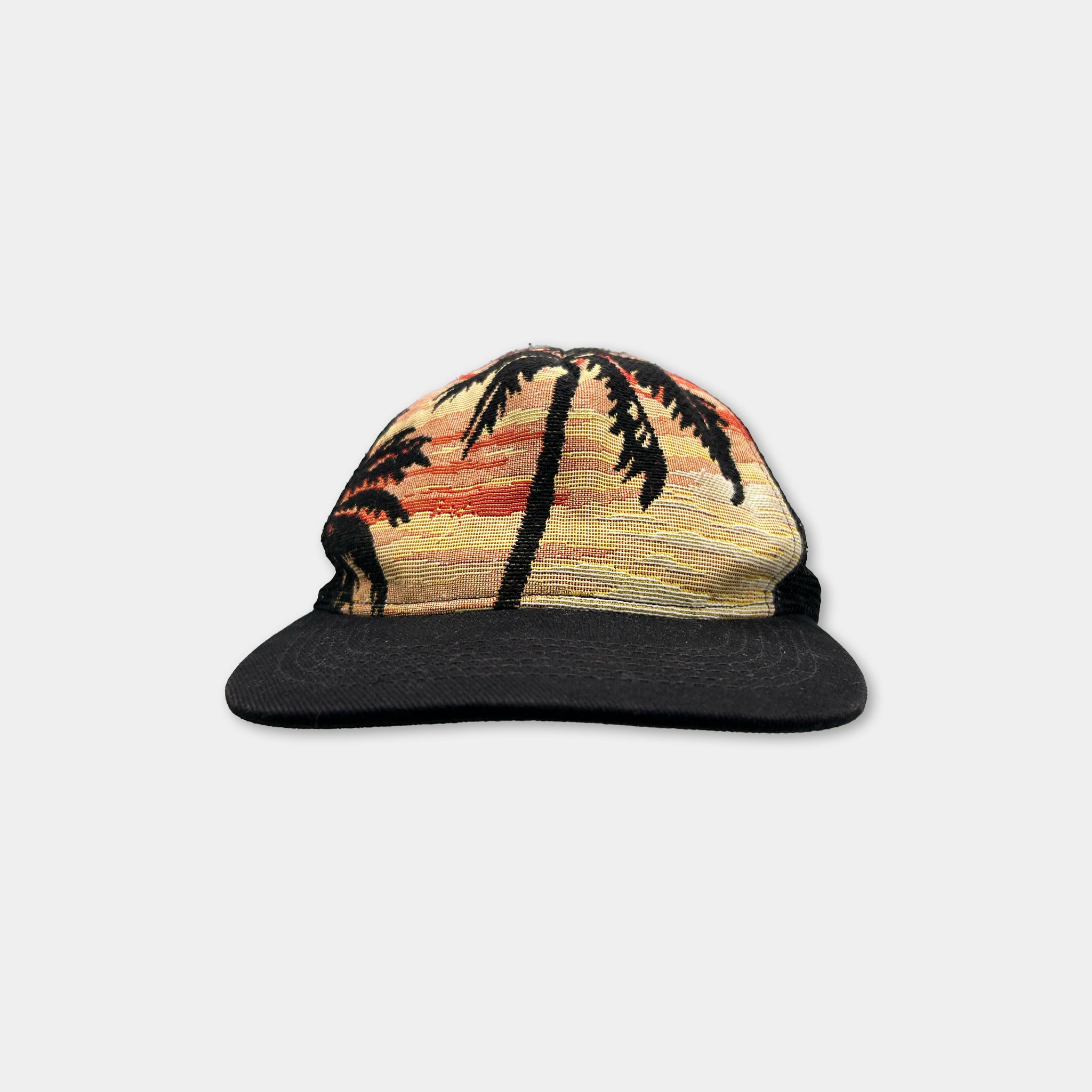 A black baseball cap with a palm tree design printed on it.